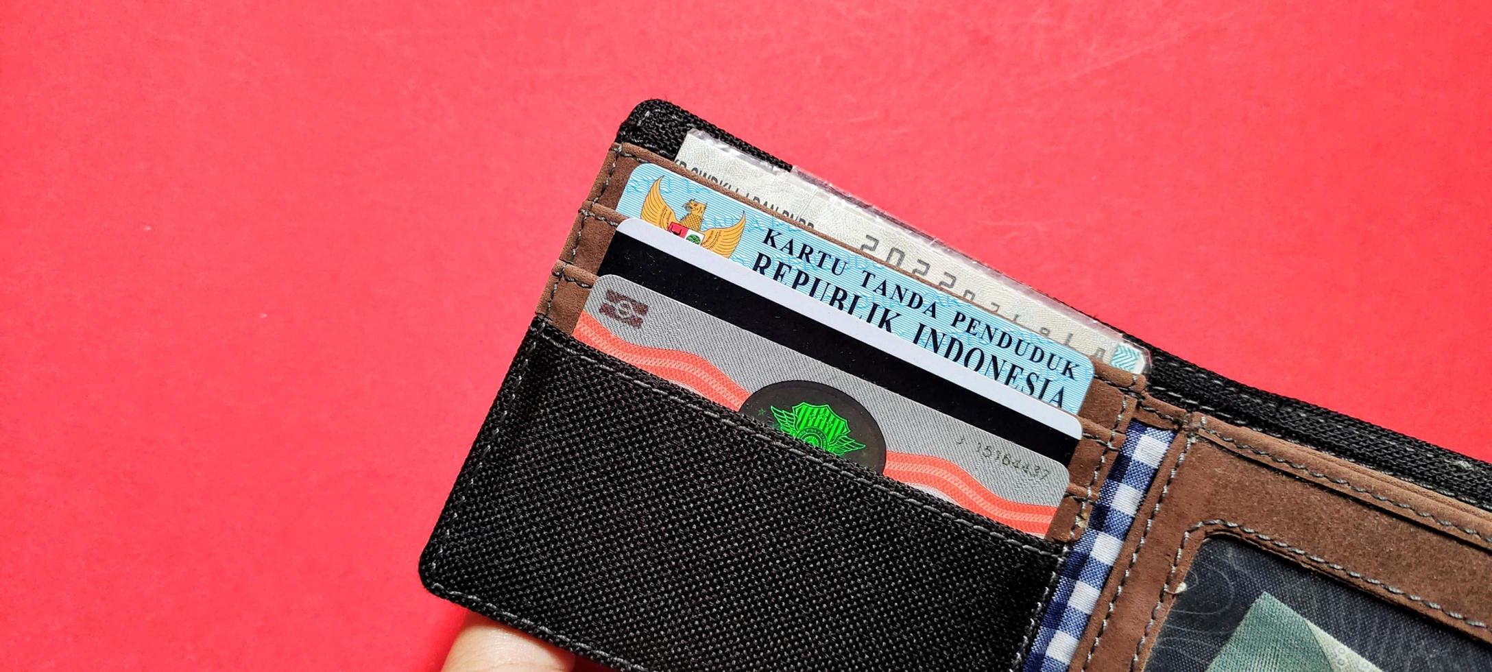 A wallet containing identity cards, driving licenses and motor vehicle certificates. photo