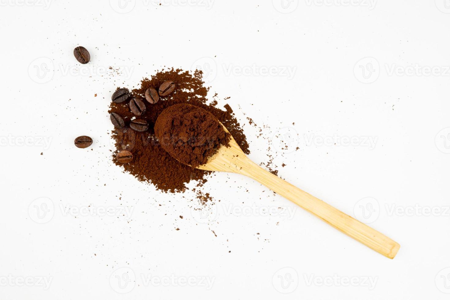 coffee beans and powder in wooden spoon photo