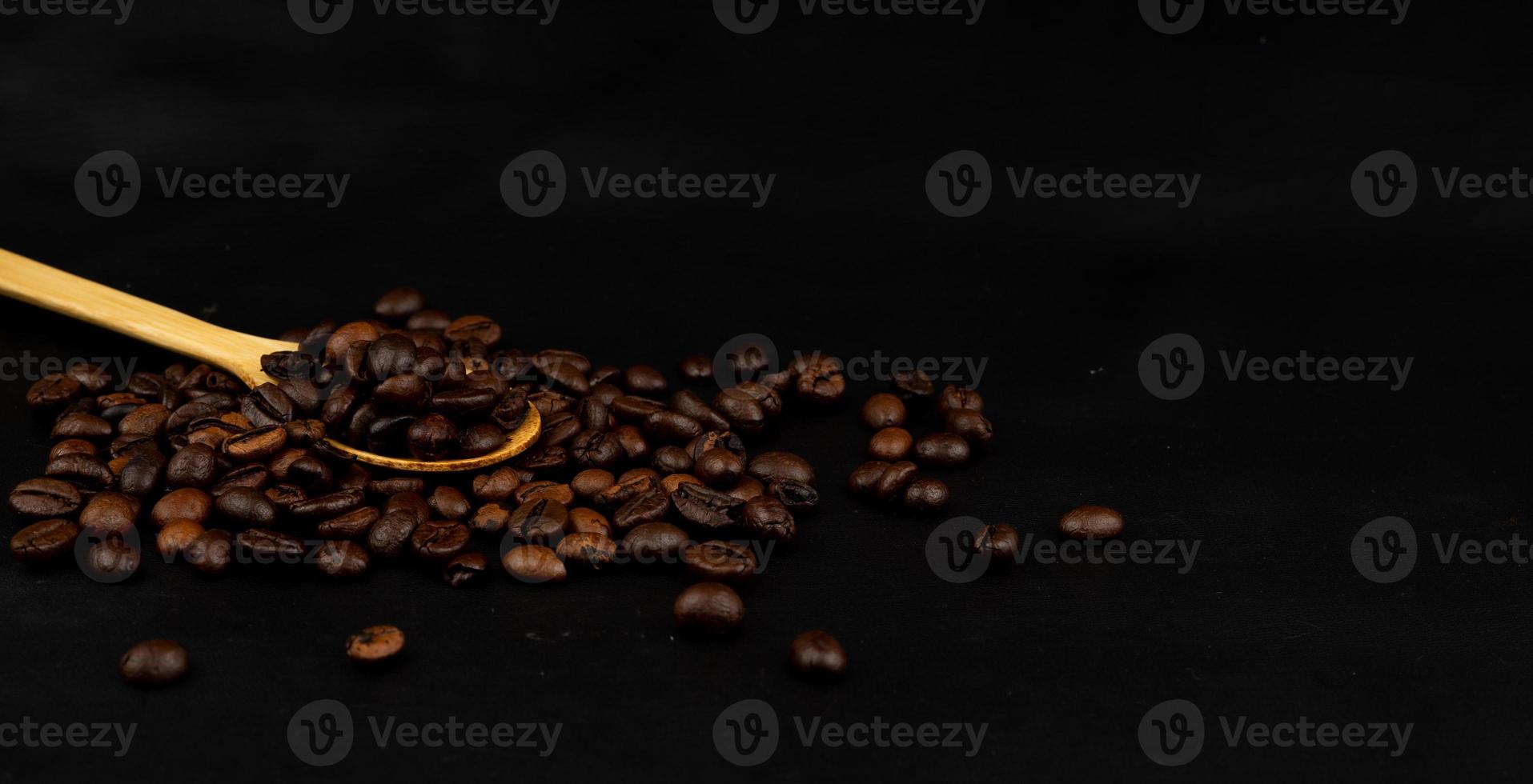 coffee beans in a wooden spoon for banner photo