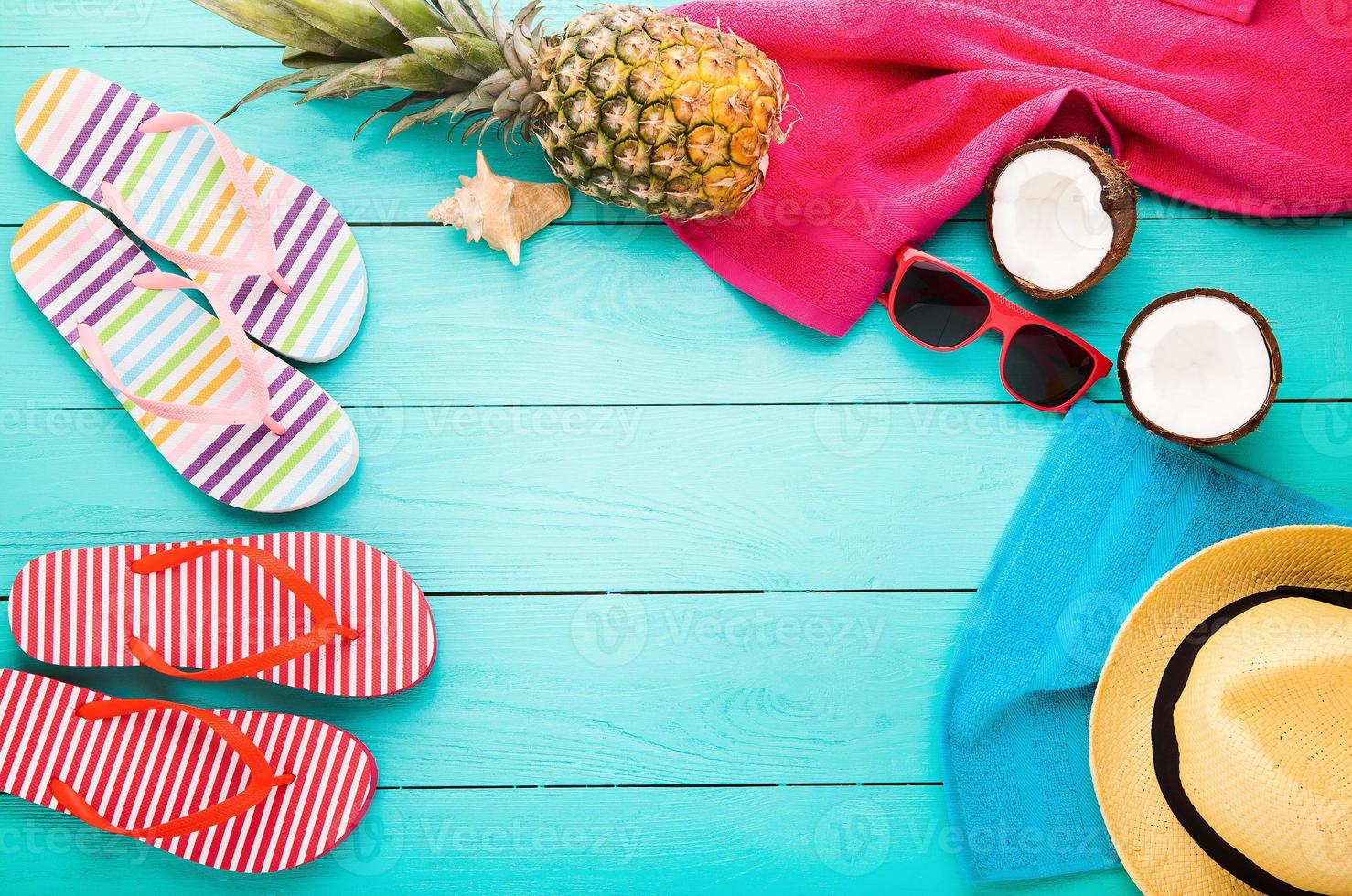 Beach accessories with copy space on blue wooden background. Top view photo