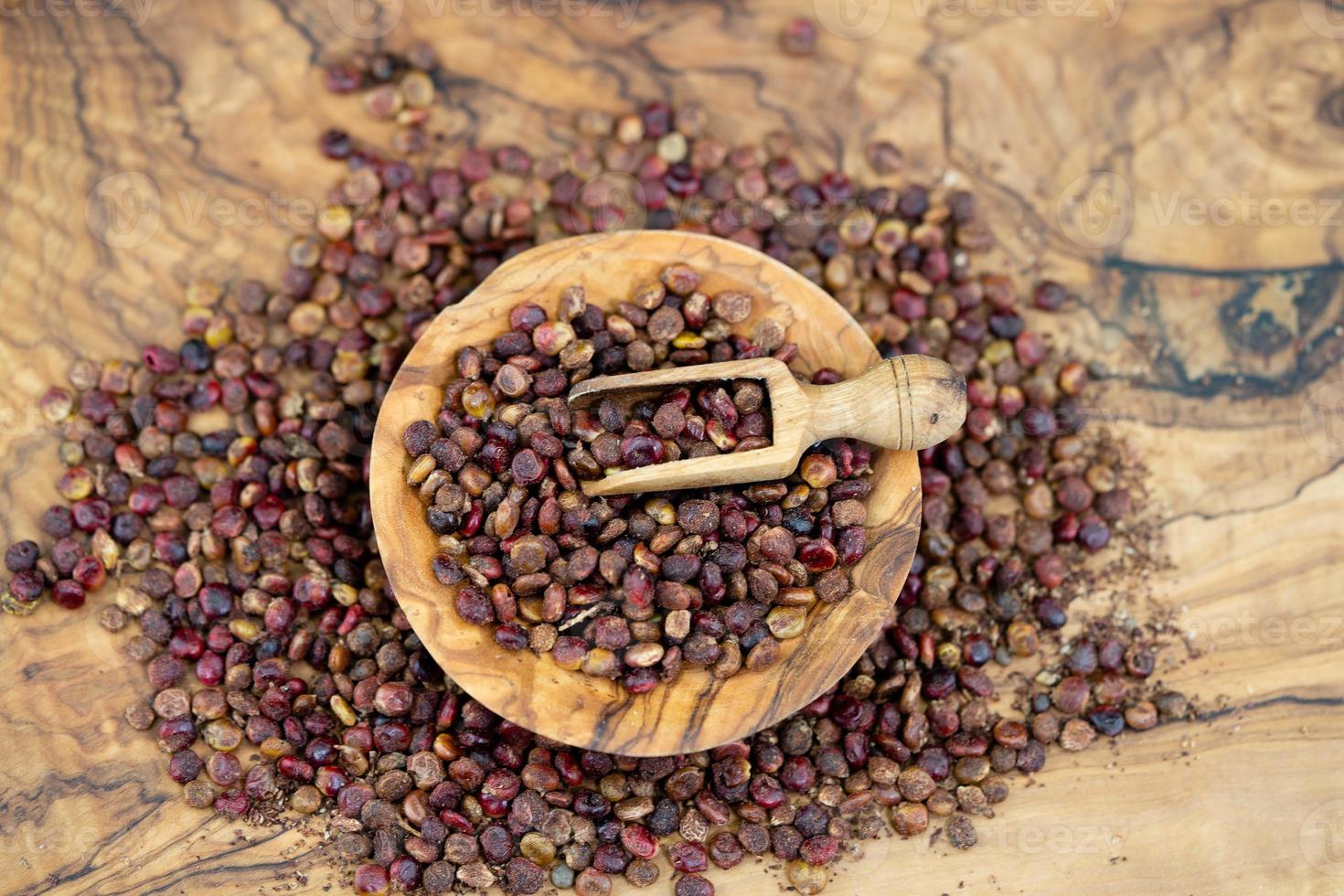 red Turkish Sumach rhus coriaria on olive wood photo