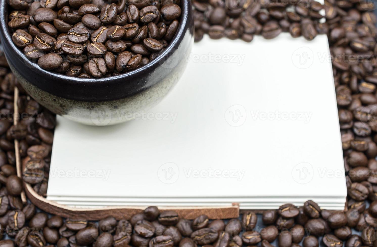 A book open the empty page with frame coffee beans background. photo