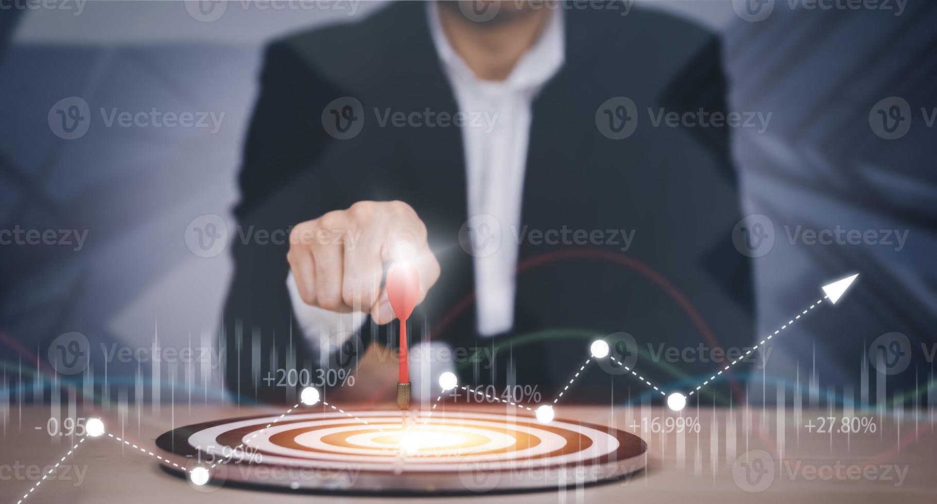Targeting the business concept, Businessman hand holding red dart to the virtual target dartboard, Executive marketing, investment goal and target for business investment concept, photo