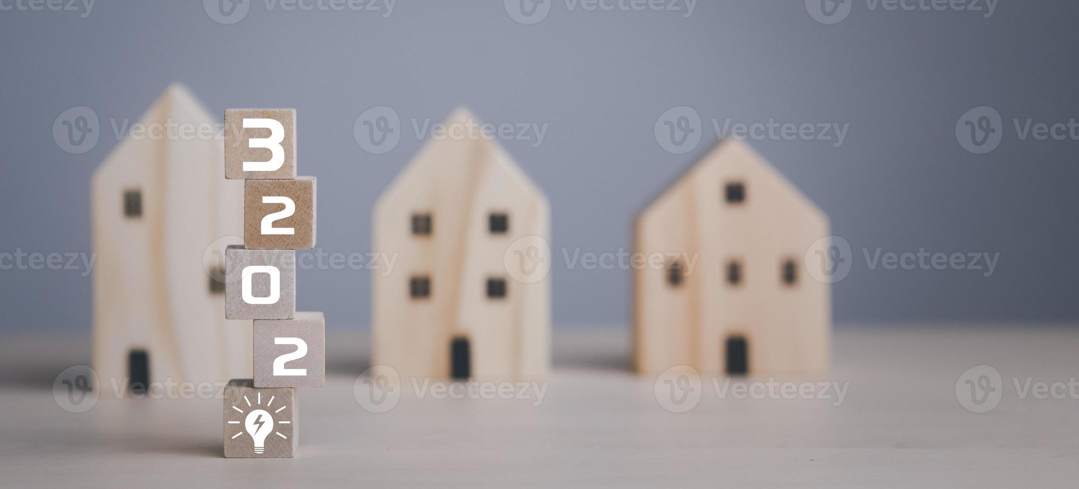 2023 with Mini wood house model from model on wood table in the nature background , Planning buy Real Estate, Planning to buy property and Choose the best. work from home and stay at home concept. photo