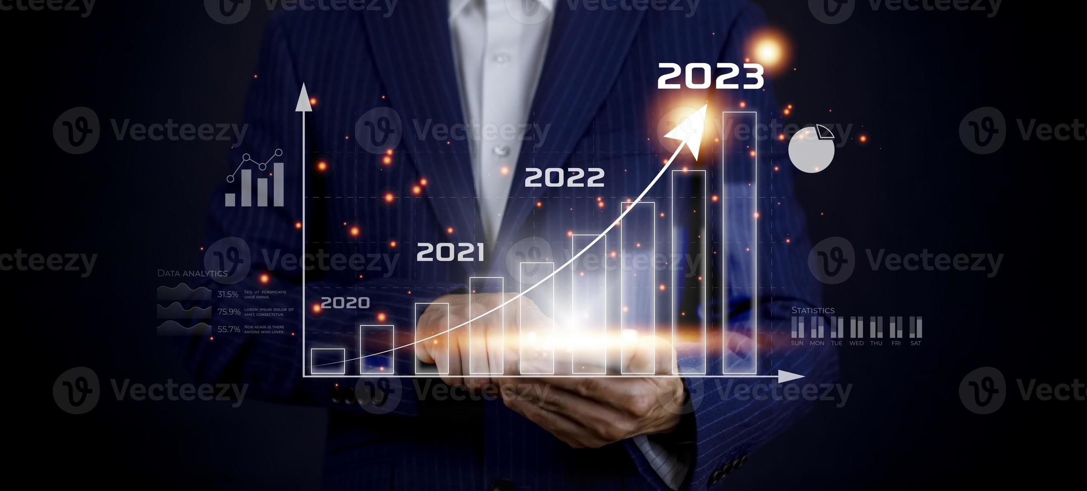 Business growth data chart arrow with diagram 2023 budget, Businessman pointing arrow graph corporate future growth year 2022 to 2023, Development to success and motivation. photo