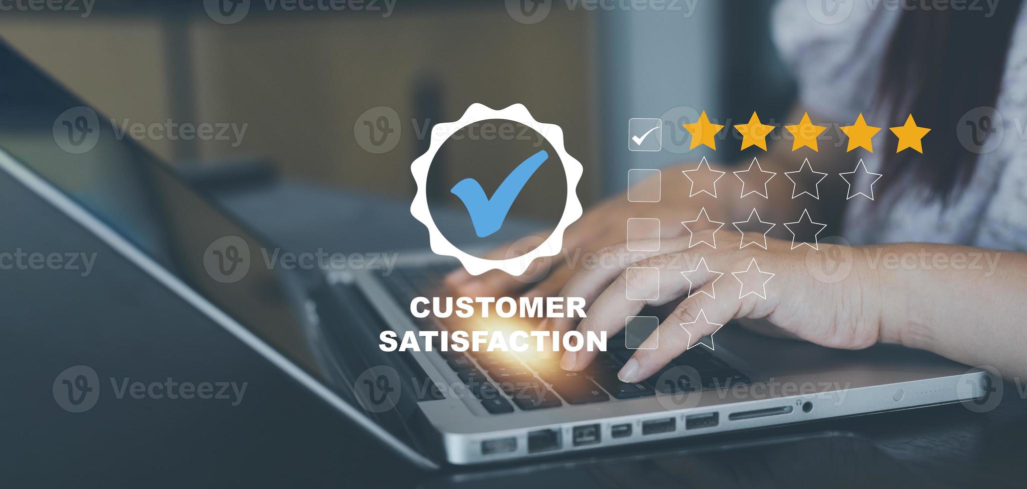 Woman Hand touch laptop with Customer review satisfaction feedback survey concept, User give rating to service experience on online application, service leading to reputation ranking of business. photo