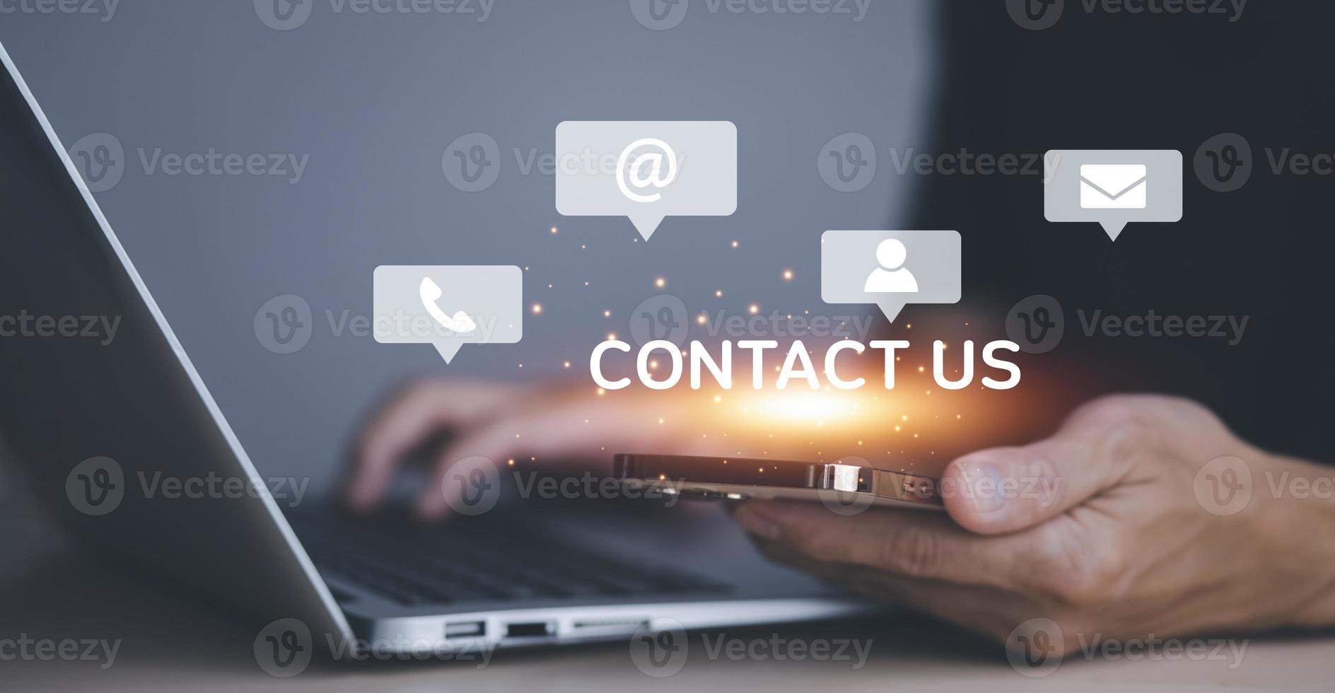 Communication and Contact us or Customer support hotline people connect. Hand using a laptop and touching on virtual screen contact icons, email and address, live chat with internet wifi. photo