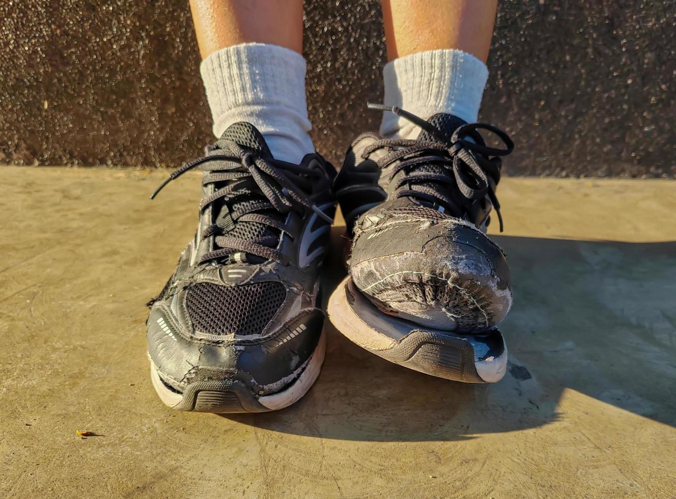 front view of torn shoes, shoes in need of repair photo