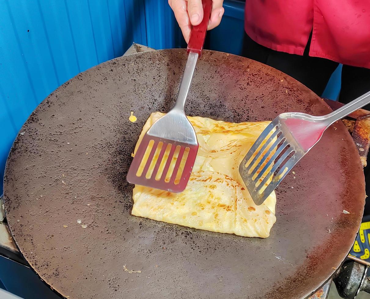 Roti which are cooking on the hot pan, small business photo