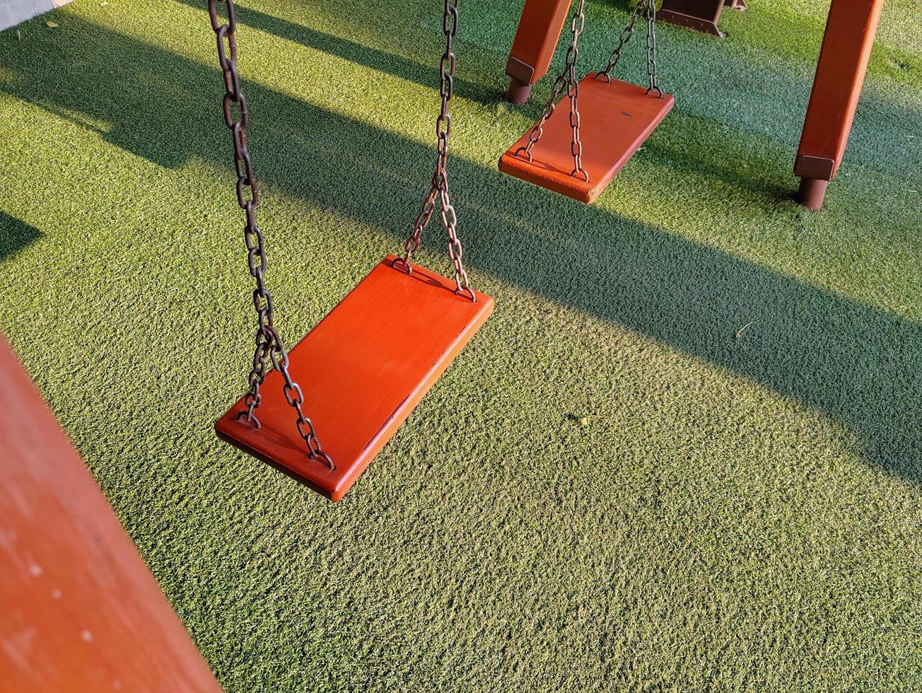 Swing playground in the morning sunlight in spring photo