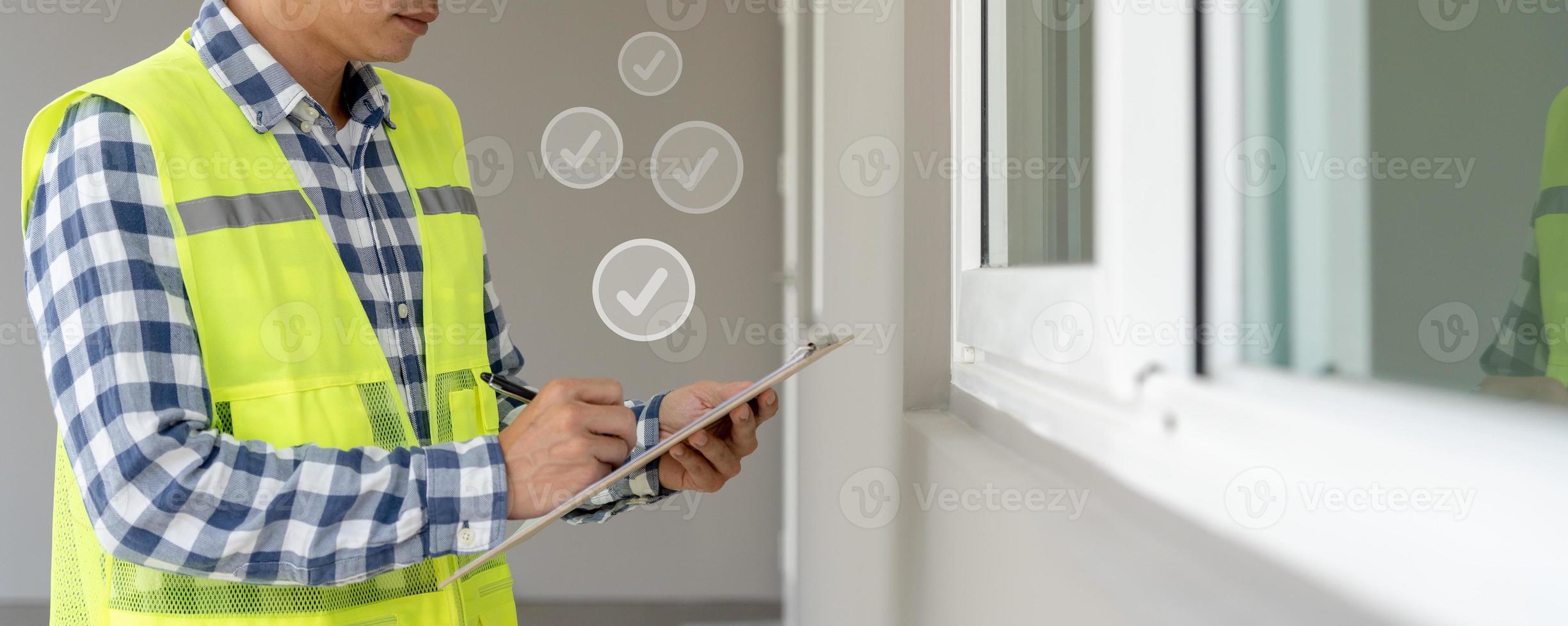 inspector or engineer is inspecting construction and quality assurance new house using a checklist. Engineers or architects or contactor work to build the house before handing it over to the homeowner photo