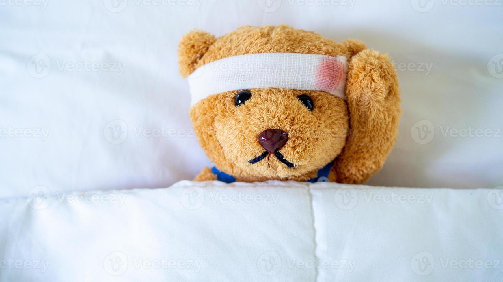 The teddy bear was sick in bed after being injured in an accident. Getting life insurance and accident insurance concept photo