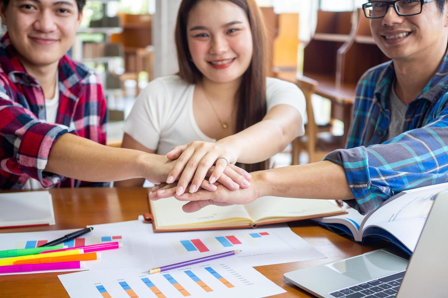 Happy Asian students brainstorm together to learn and study mathematical statistics in the university classroom. photo