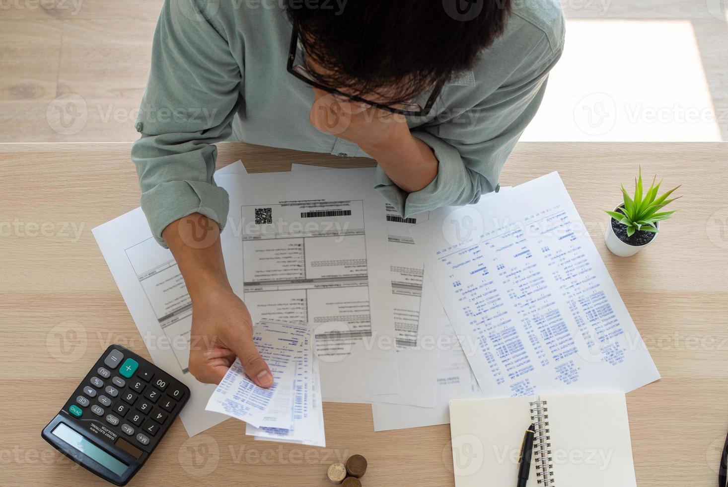 Business men are experiencing debt problems sitting stressful on your desk with a lot of documents and bills. Concept of debt photo