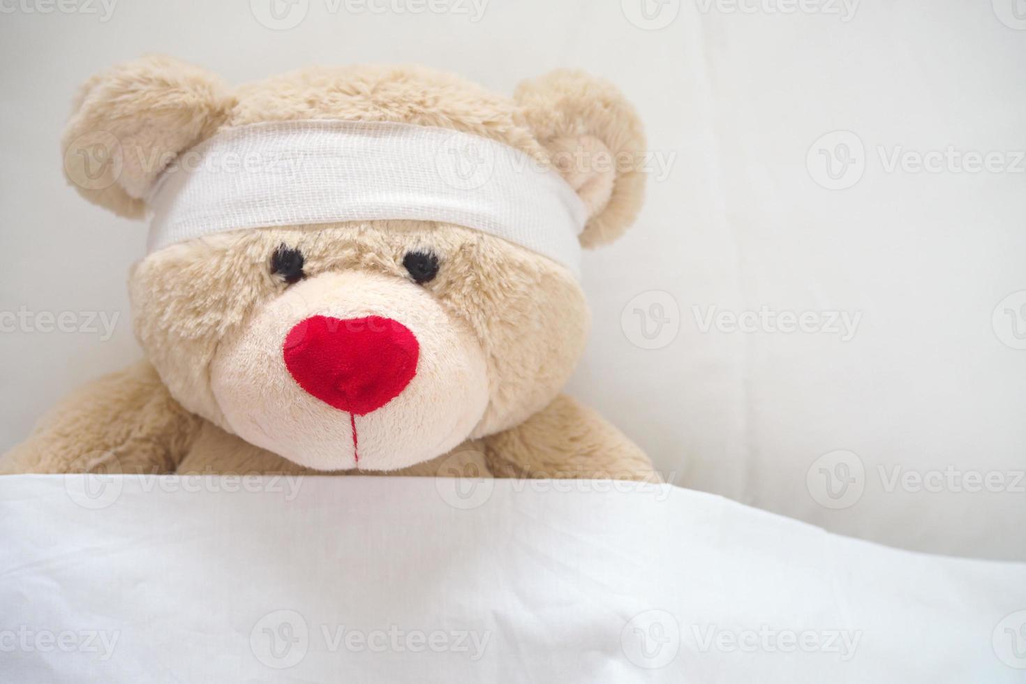 The teddy bear has gauze on the head. Child Injury Concept photo