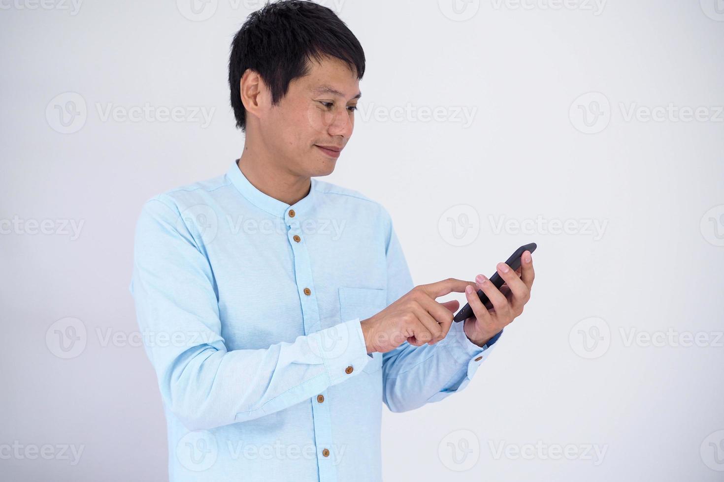 Happy businessman uses a smartphone. photo