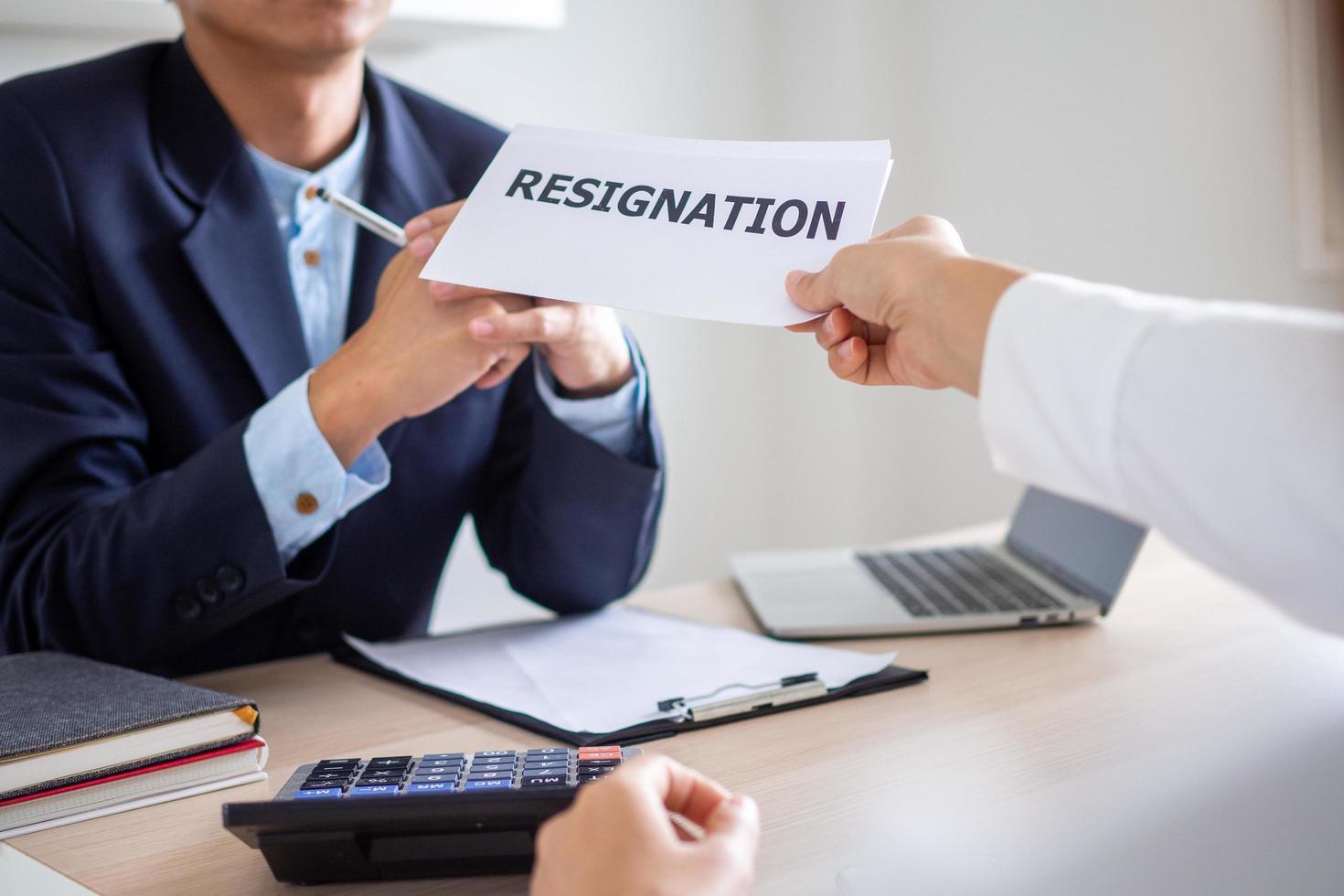 Employee businessman submit or sending resignation document letter to human resource manager or boss, Change of job, unemployment, resign concept. photo