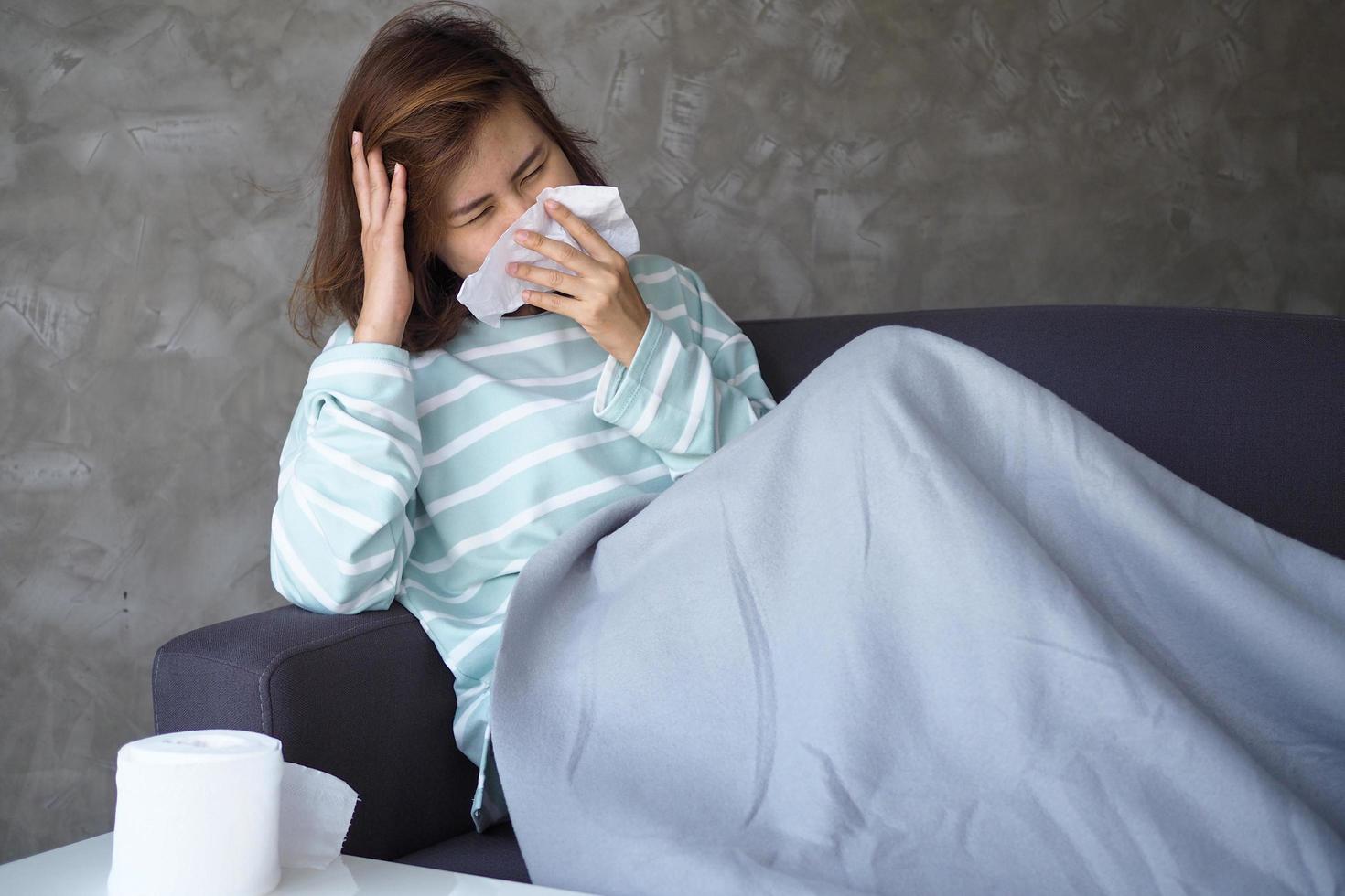 Asian women have severe headache and runny nose. After being bitten by mosquitoes photo