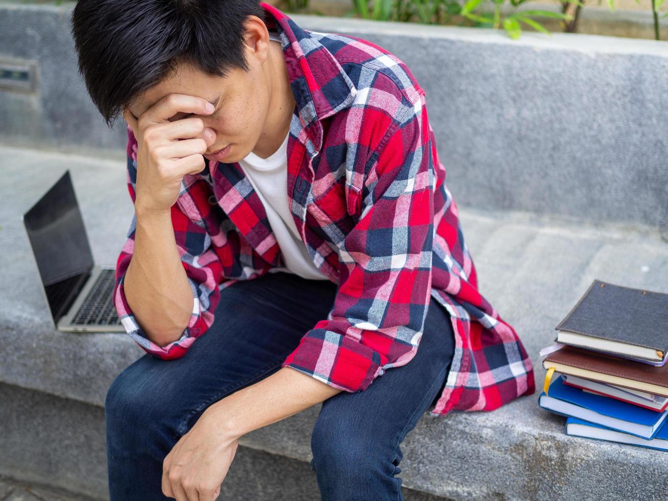 Asian male students were disappointed with the results of the entrance examination for the university. Sadness and upset photo