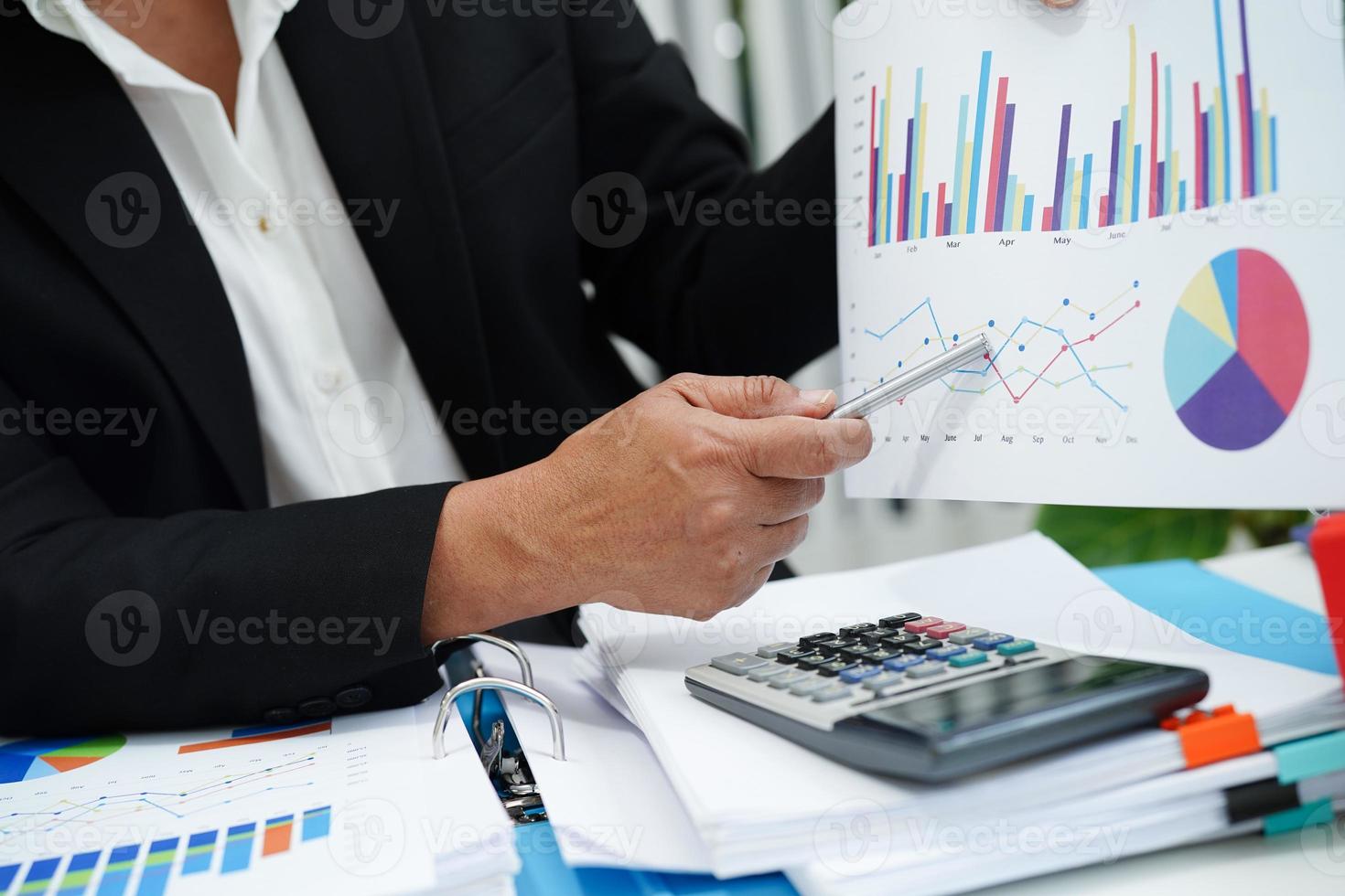 Business woman working and analysis with statistic graph in office. photo