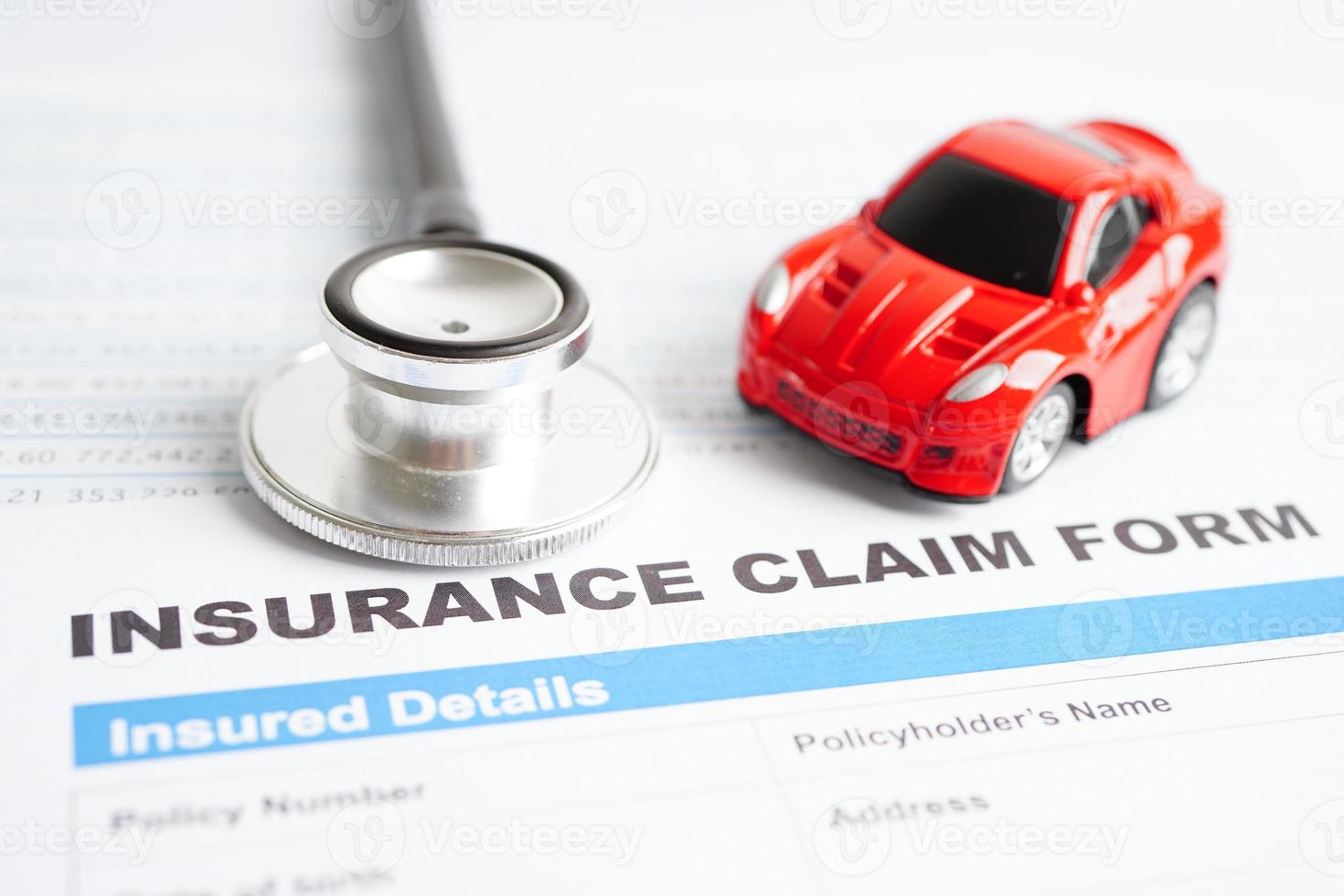 Stethoscope on Insurance claim accident car form, Car loan, insurance and leasing time concepts. photo