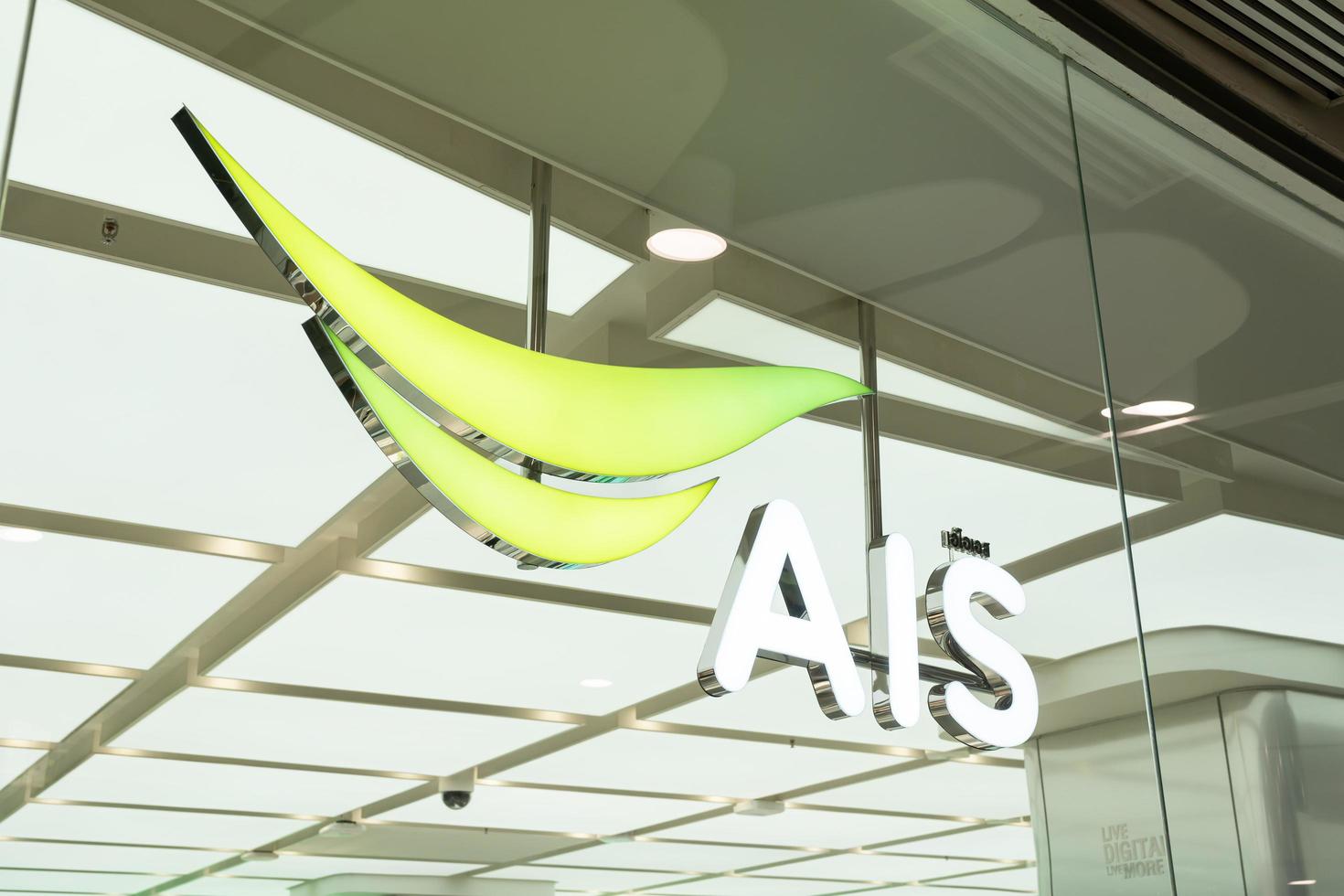 Bangkok Thailand Feb 23 2023 AIS logo at Central World. One of mobile service opertor in Thailand provide voice and data service including iot and smart devices to create tecnology system photo