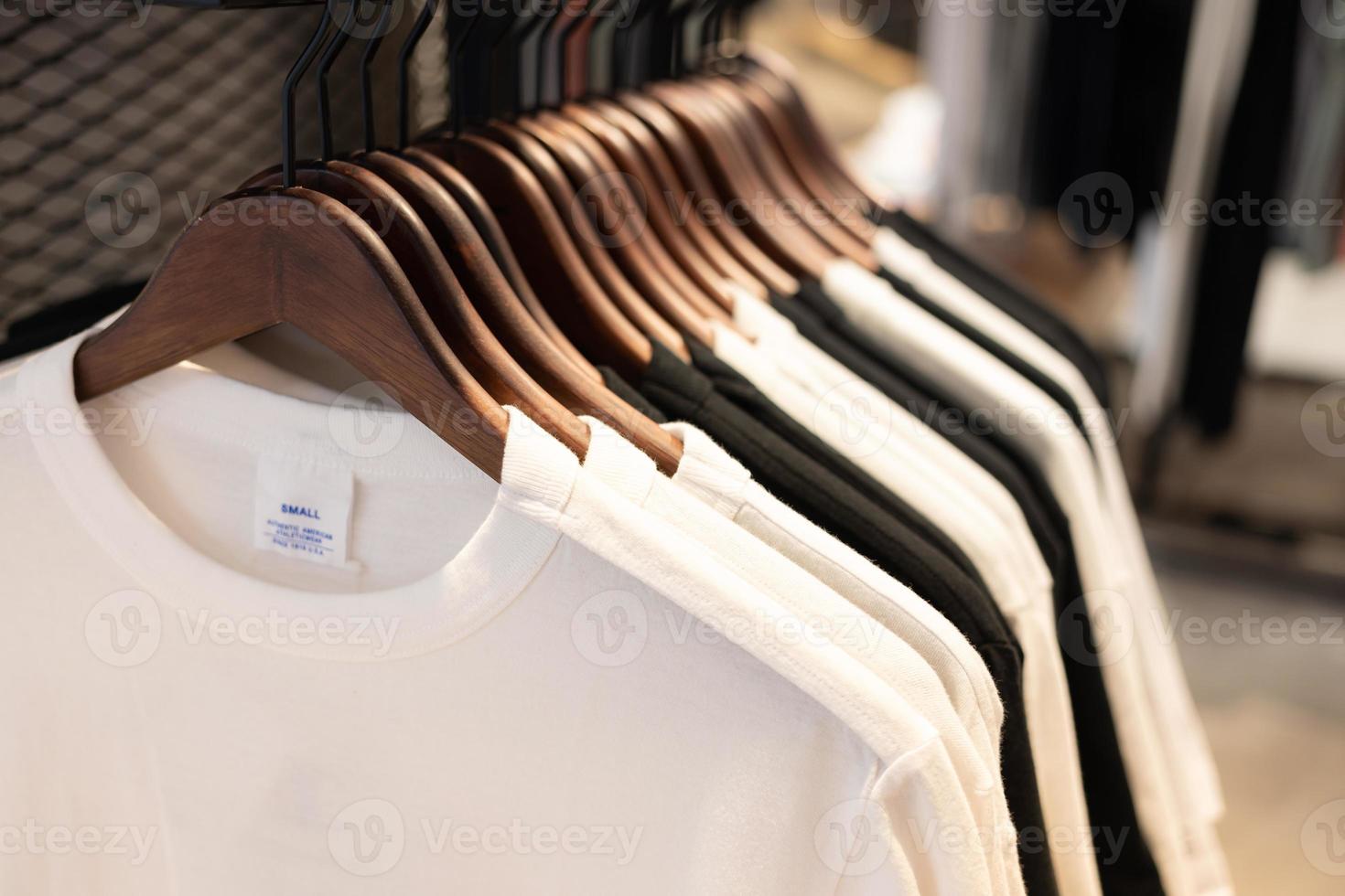 clothes on clothing rack. gray t-shirt  wear on hangers in closet or spring cleaning concept. Summer home wardrobe. Clothing hanging on a clothing rack in a shop or home closet. selective focus. photo