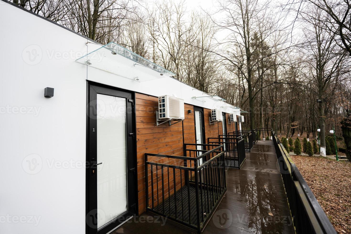 Terrace of one-storey modular houses in spring rainy forest. photo