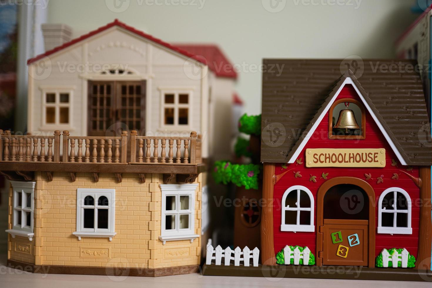 Red school house with bell plastic toy. photo