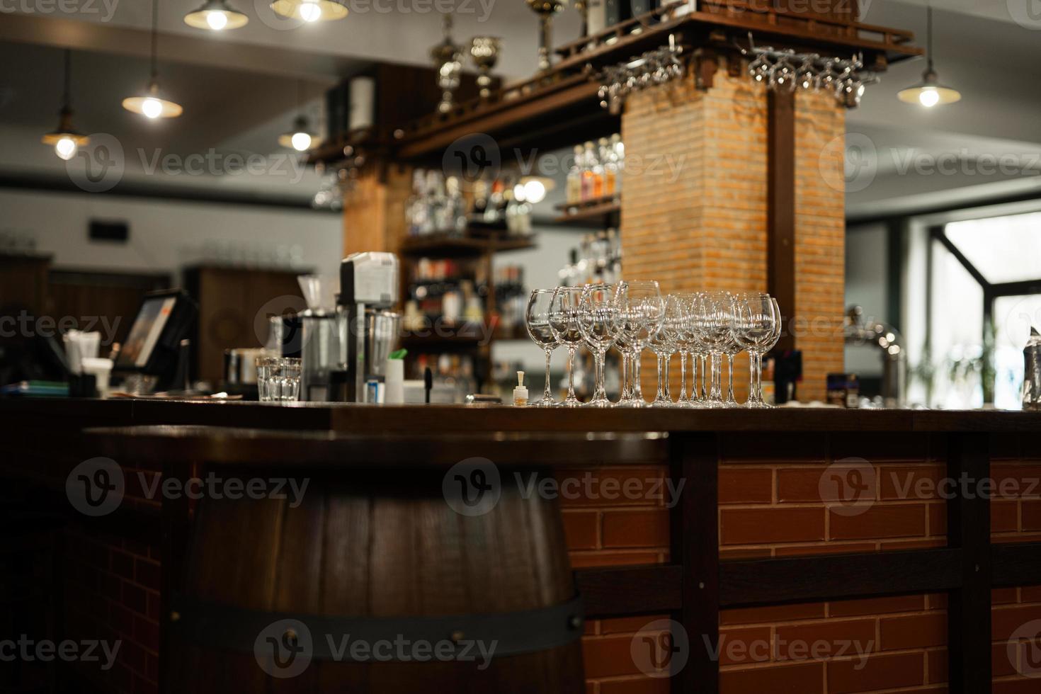 Empty bar with old barrel interior,  wooden furniture and pub counter without bartenders. photo