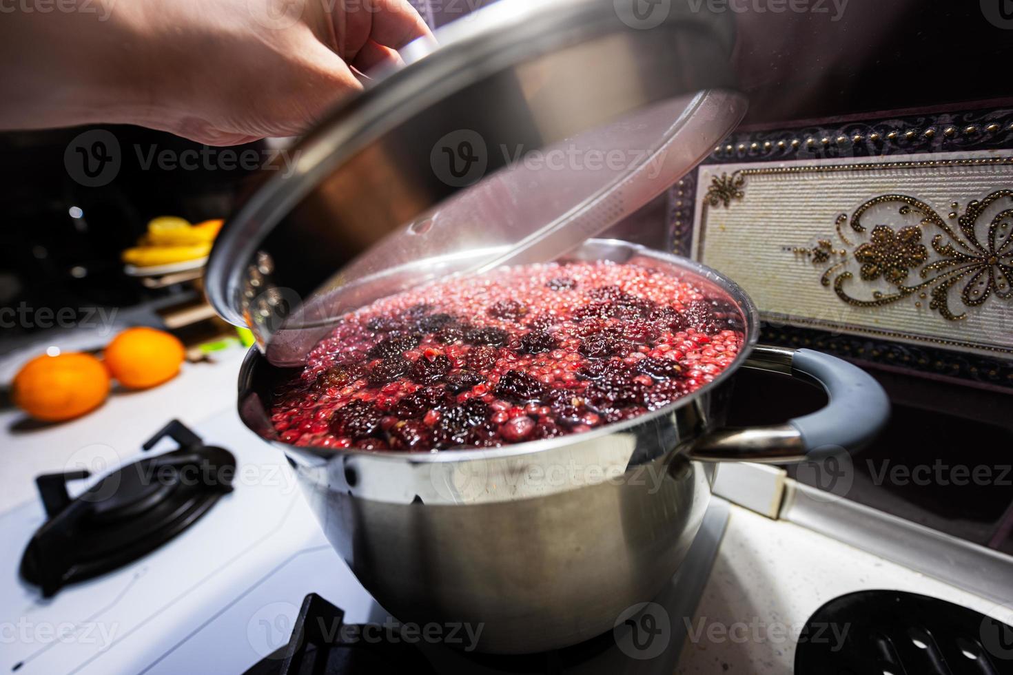 Cooking pot with delicious berries compote. photo