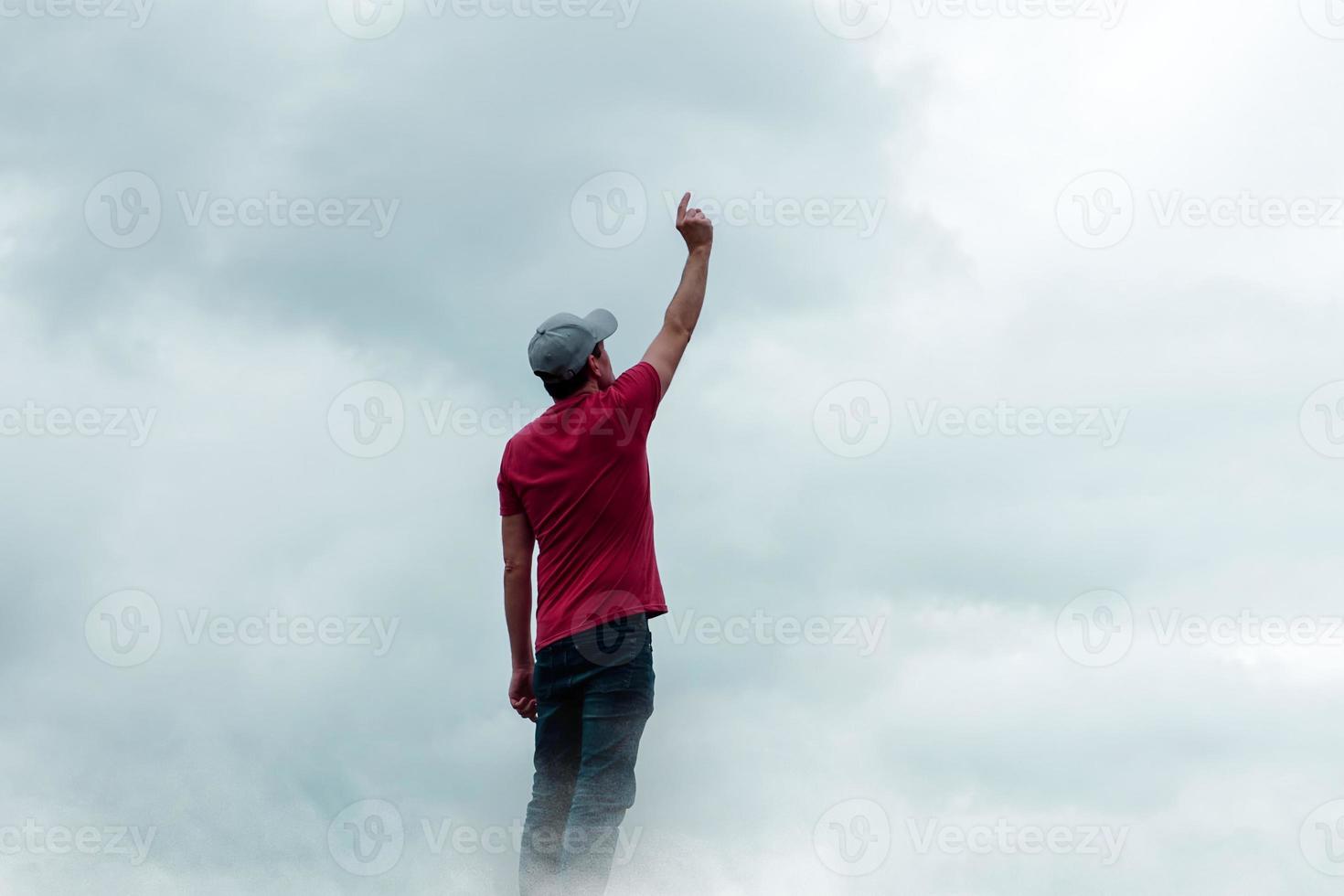 man portrait gesturing in the sky and clouds photo