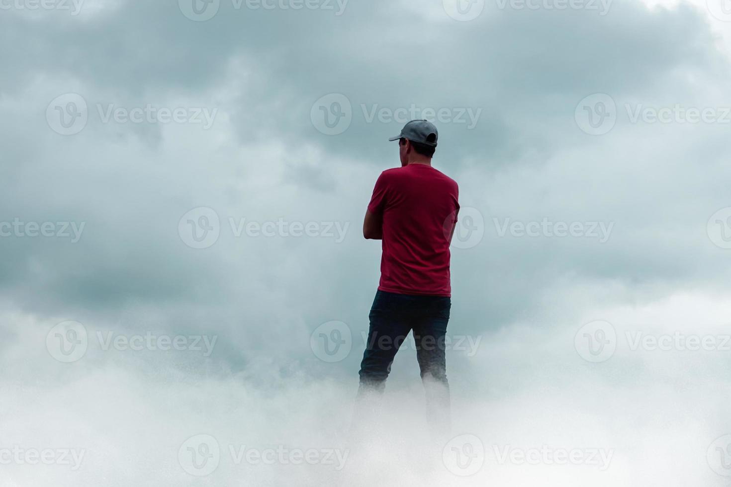 man portrait gesturing in the sky and clouds photo