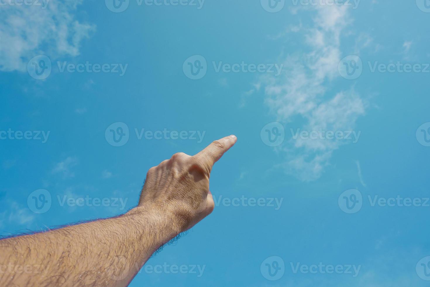 mano arriba gesticulando en el cielo azul, sentimientos y emociones foto