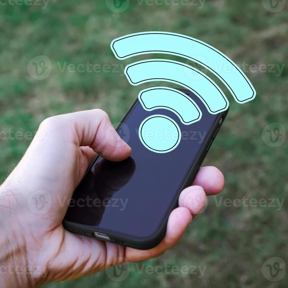 mano participación un inteligente teléfono con Wifi icono, inalámbrico fidelidad foto