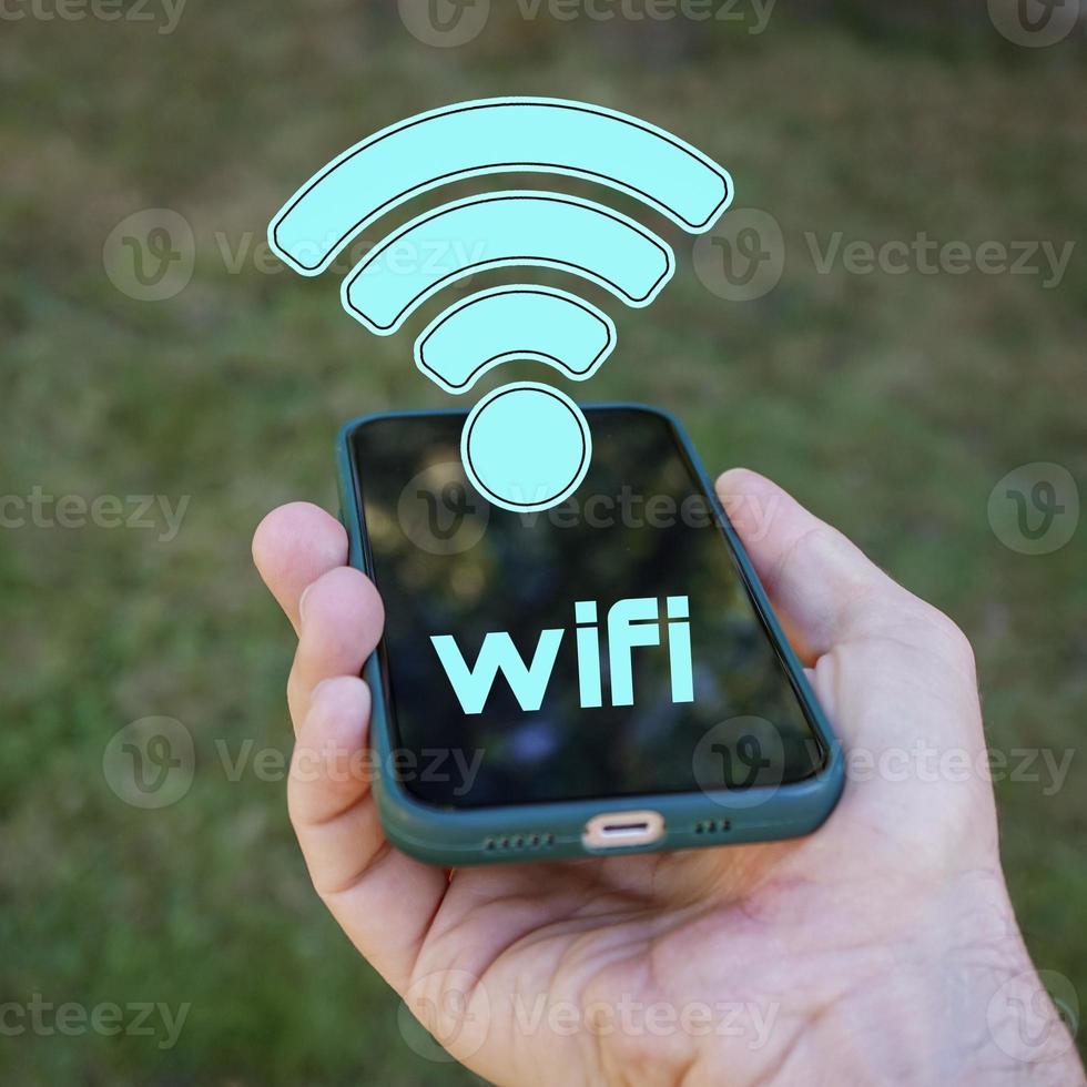 hand holding a smart phone with wifi icon, Wireless Fidelity photo