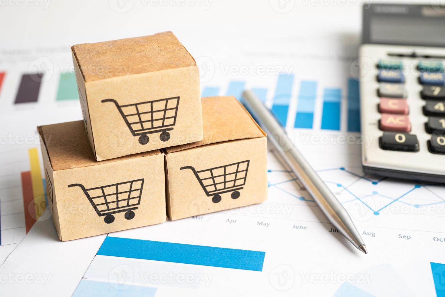 Shopping cart logo on box with magnifying glass on graph background. Banking Account, Investment Analytic research data economy, trading, Business import export transportation online company concept. photo