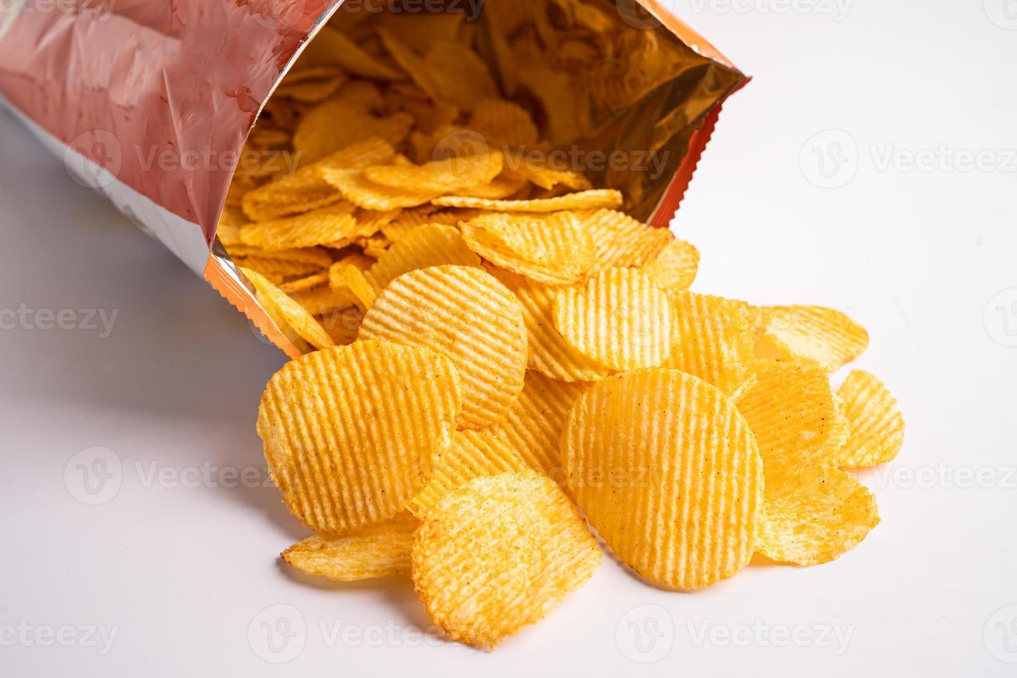 Potato chips, delicious BBQ seasoning spicy for crips, thin slice deep fried snack fast food in open bag. photo