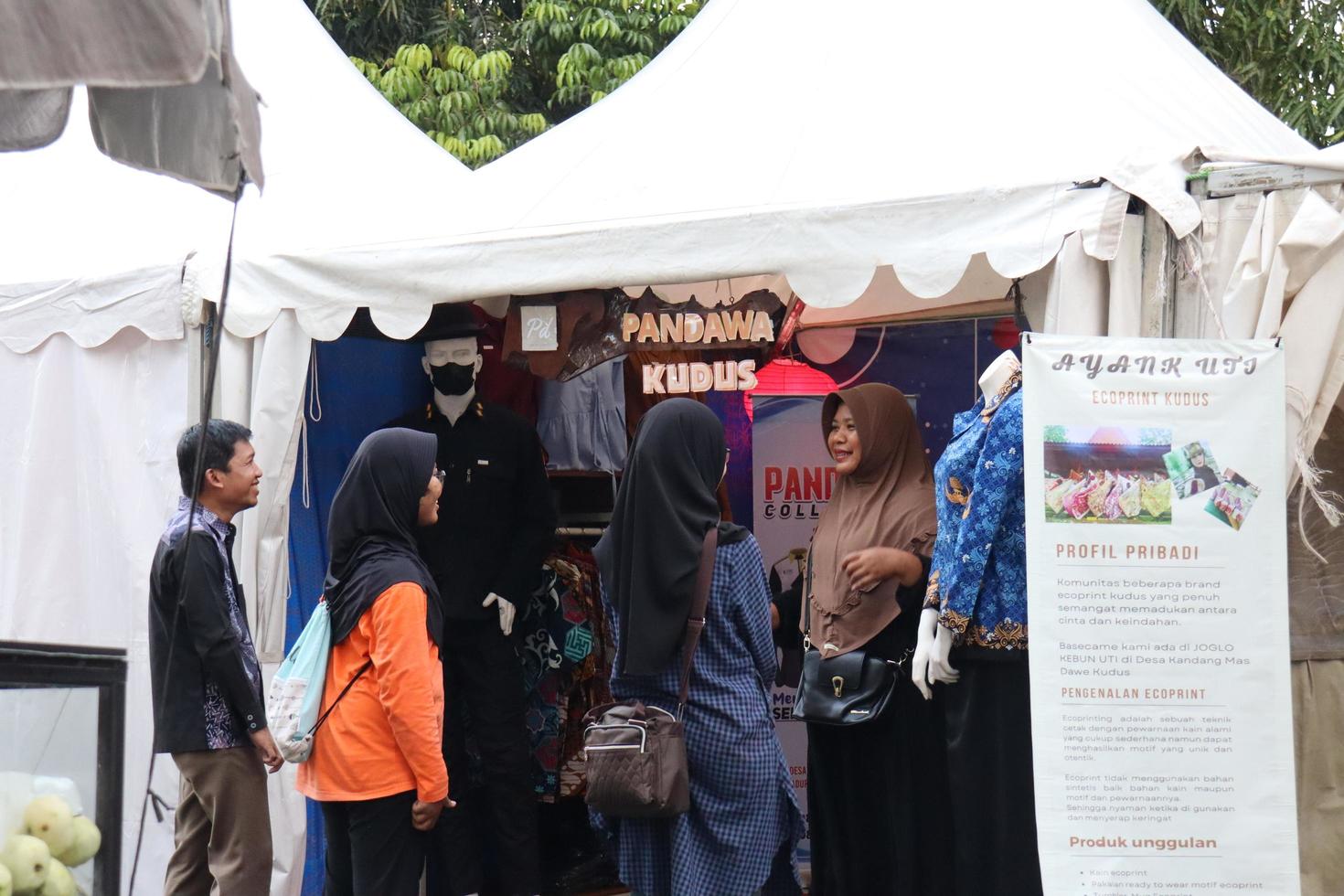 Kudus, December 2022. Photo portrait of the Kudus Expo Micro, Small and Medium Enterprises, with various kinds of clothing, food and drinks. located in the Kudus square crowded with seller visitors.