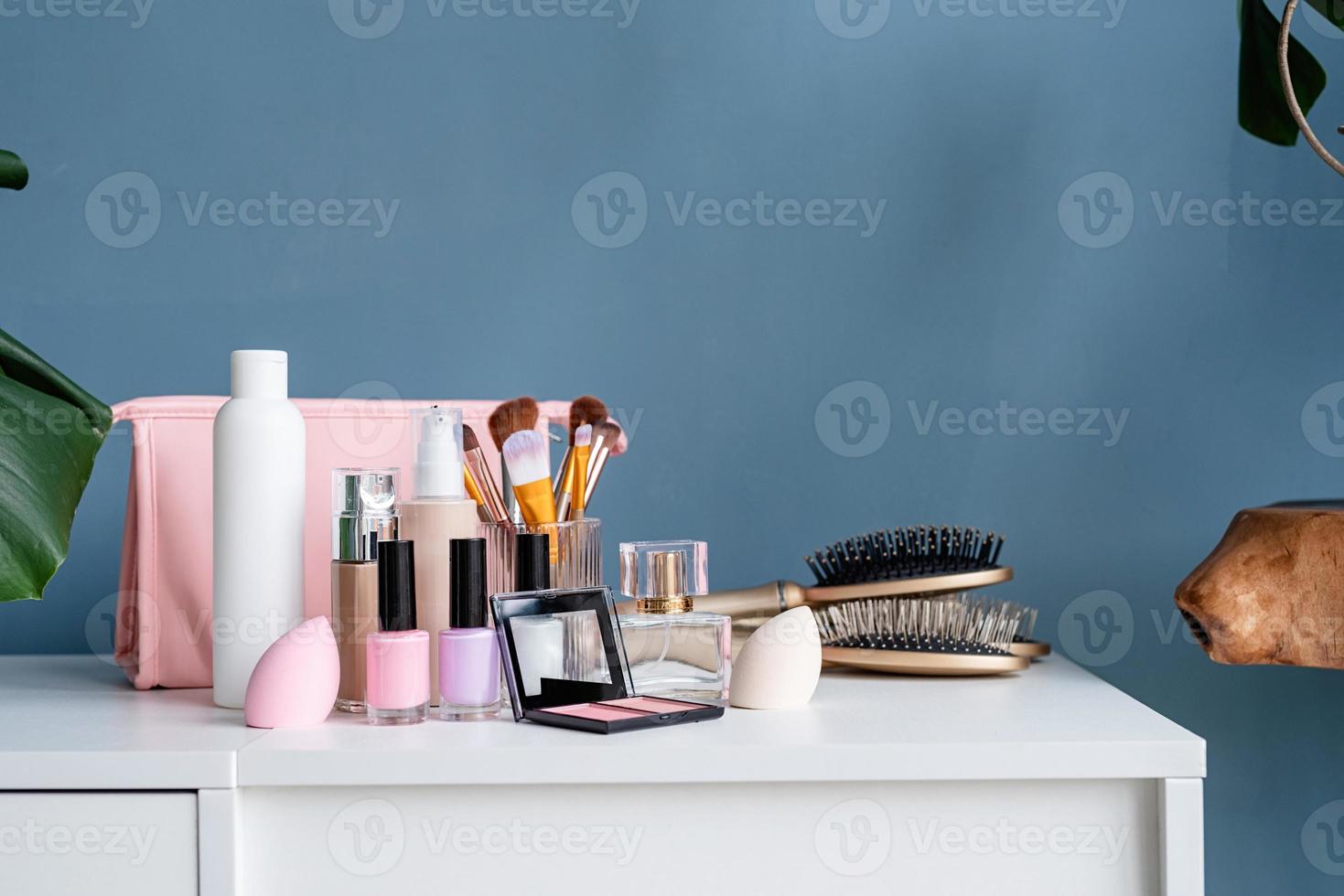 closeup of feminine cosmetic products standing on dressing table photo
