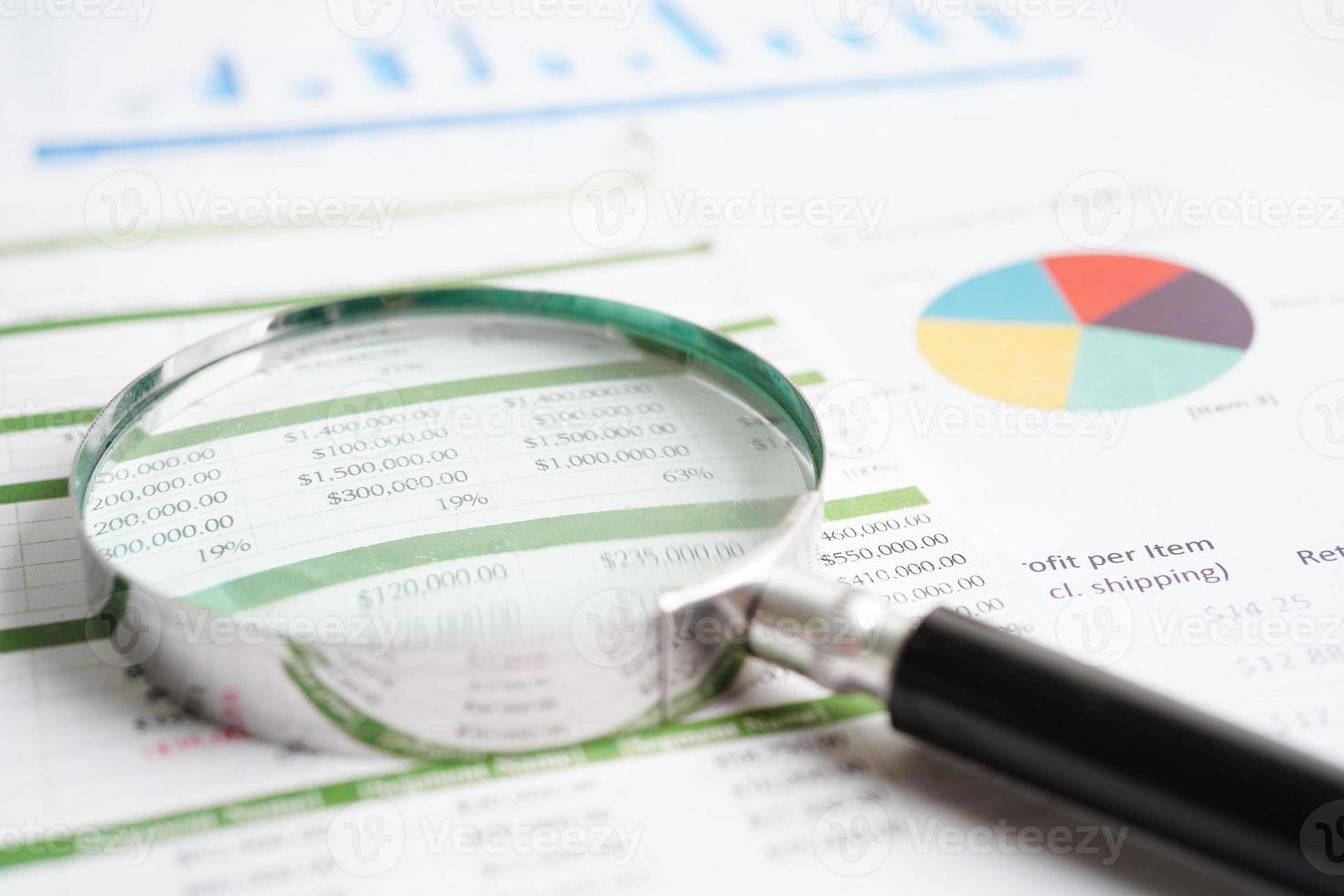 Magnifying glass on charts graphs paper. Financial development, Banking Account, Statistics, Investment Analytic research data economy. photo