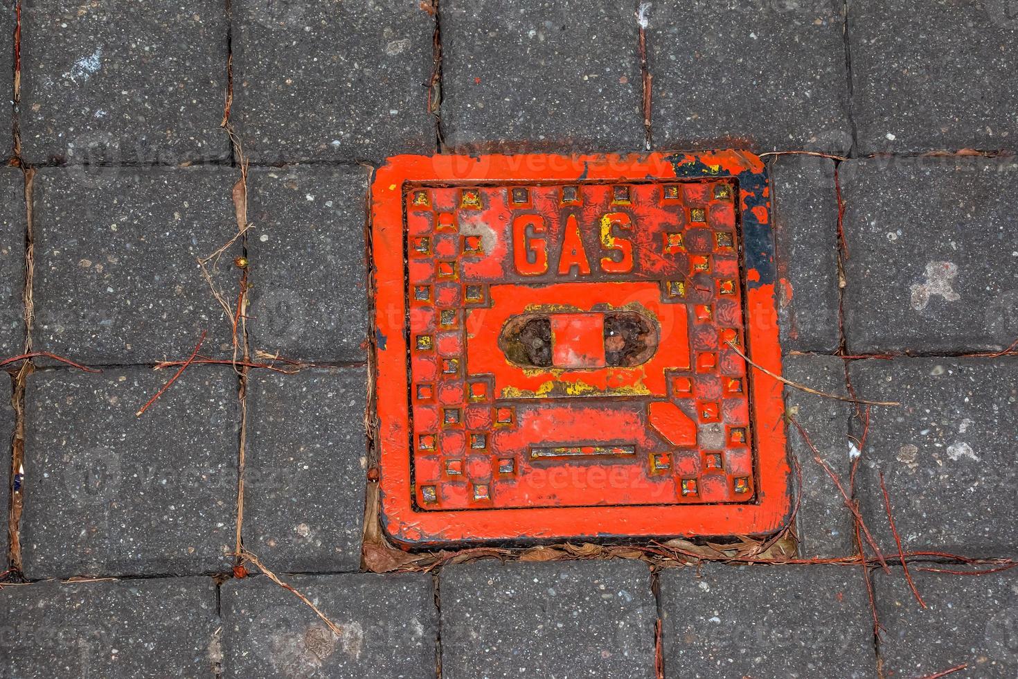 Manhole cover of the gas pipeline system. A massive metal hatch for access to city communications in the pavement. photo