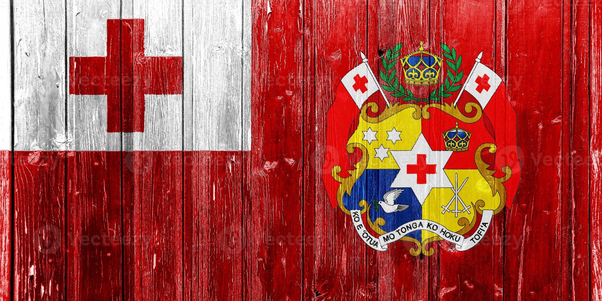 Flag and coat of arms of the Kingdom of Tonga on a textured background