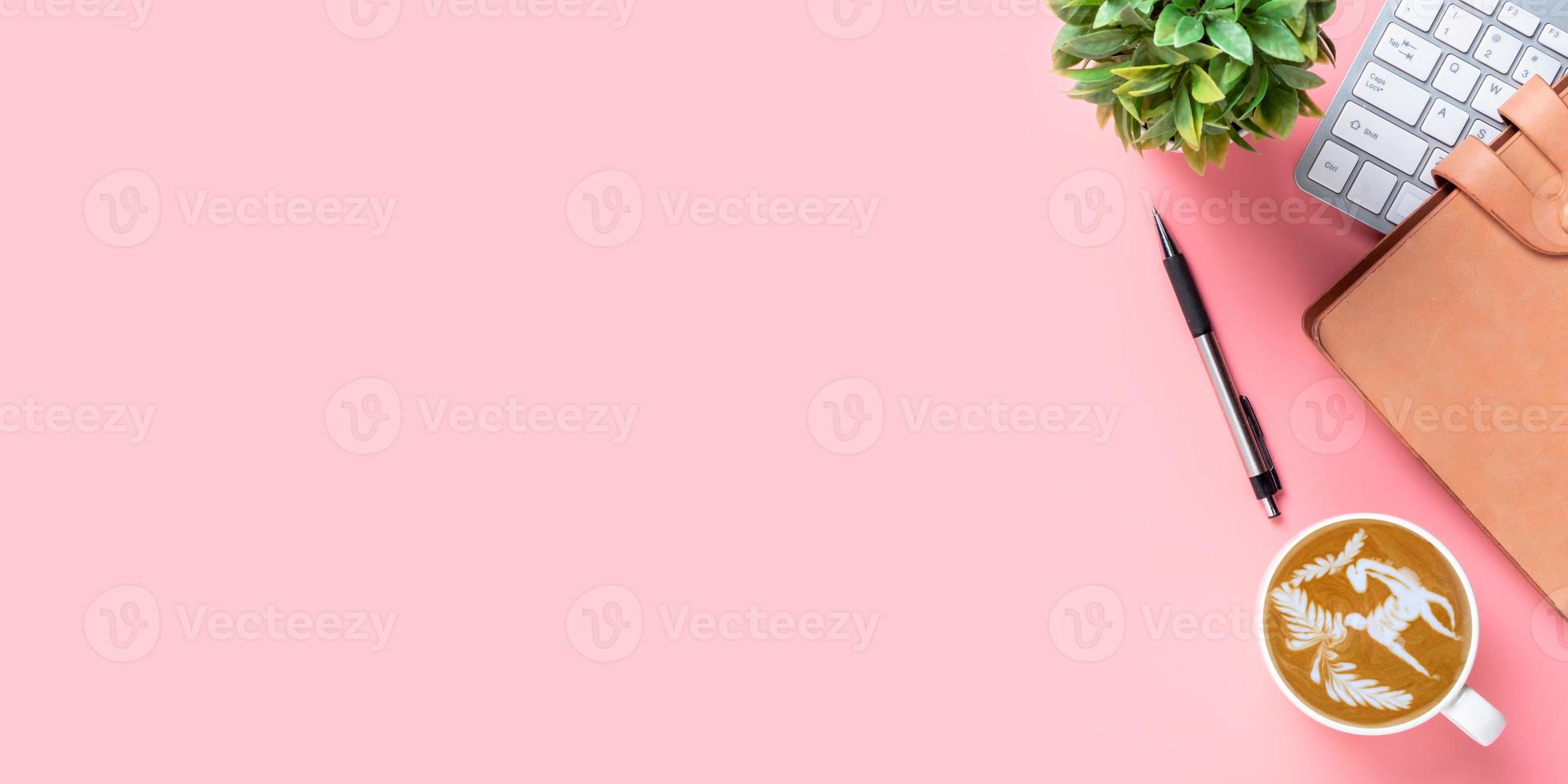 Office desk with keyboard computer, Pen, notebook, Cup of coffee on white background, Top view with copy space, Mock up. photo