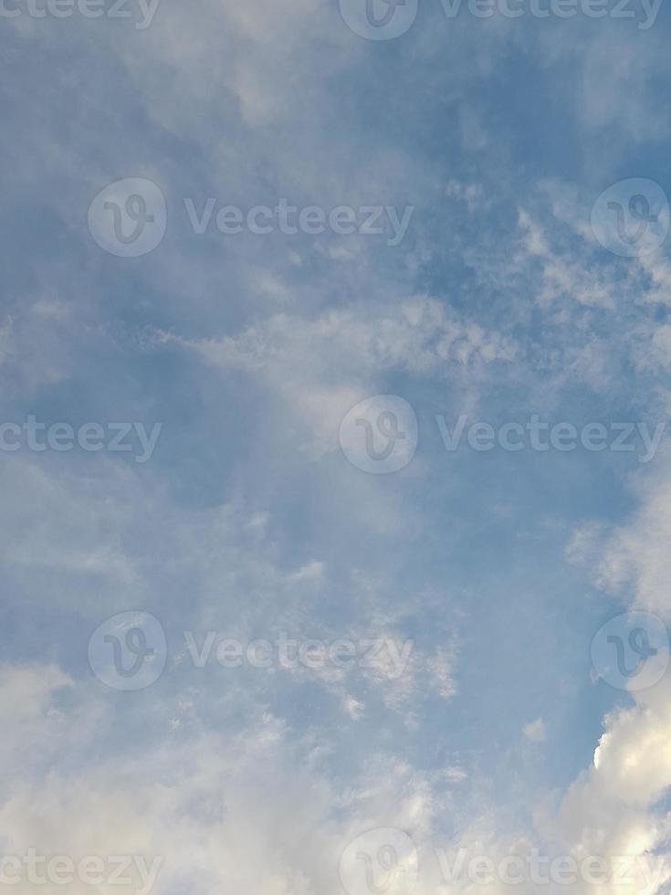 Beautiful white clouds on deep blue sky background. Large bright soft fluffy clouds are cover the entire blue sky. photo