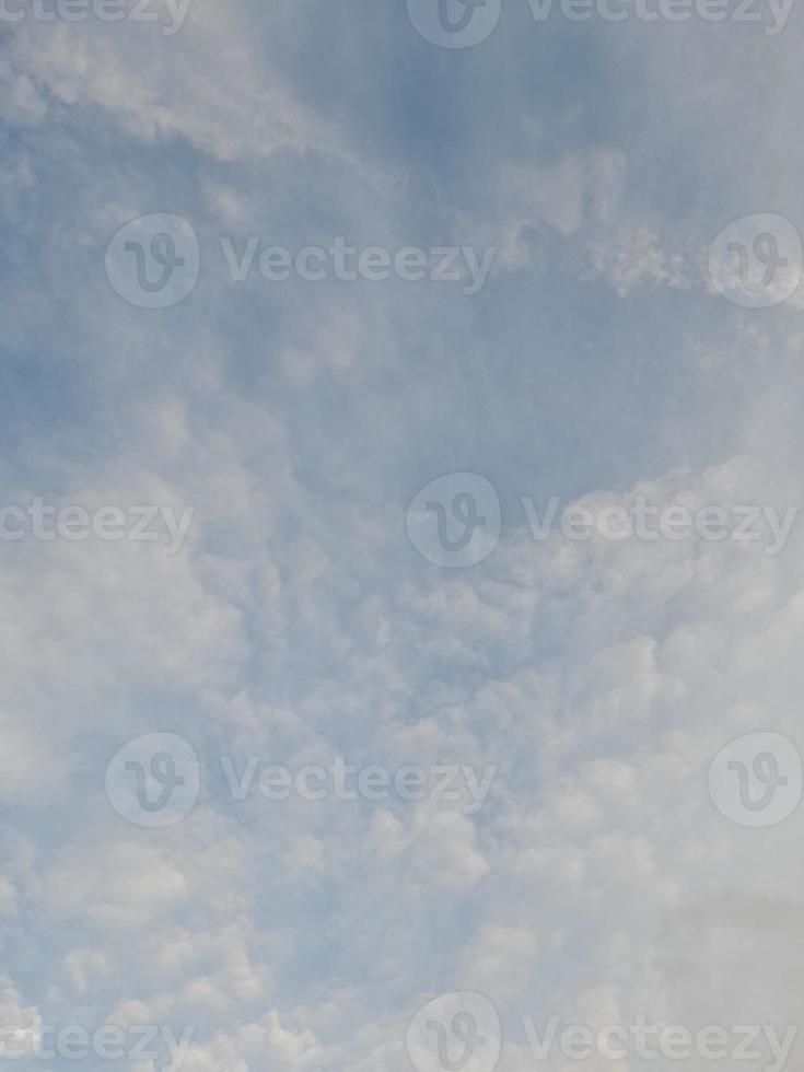 Beautiful white clouds on deep blue sky background. Large bright soft fluffy clouds are cover the entire blue sky. photo