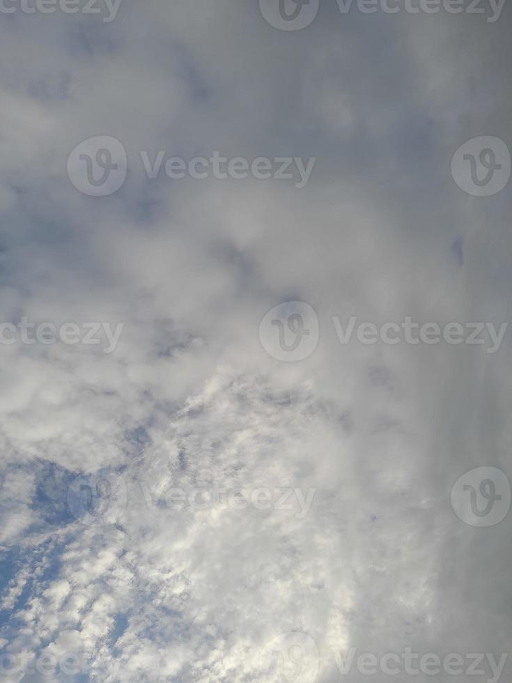 Beautiful white clouds on deep blue sky background. Large bright soft fluffy clouds are cover the entire blue sky. photo