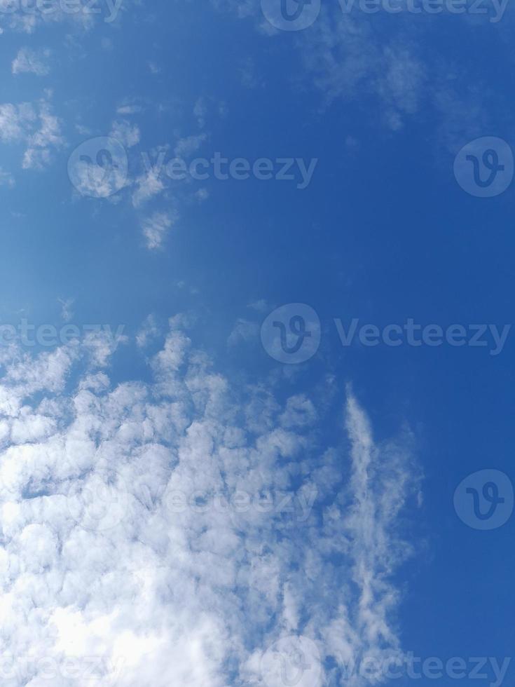Beautiful white clouds on deep blue sky background. Large bright soft fluffy clouds are cover the entire blue sky. photo