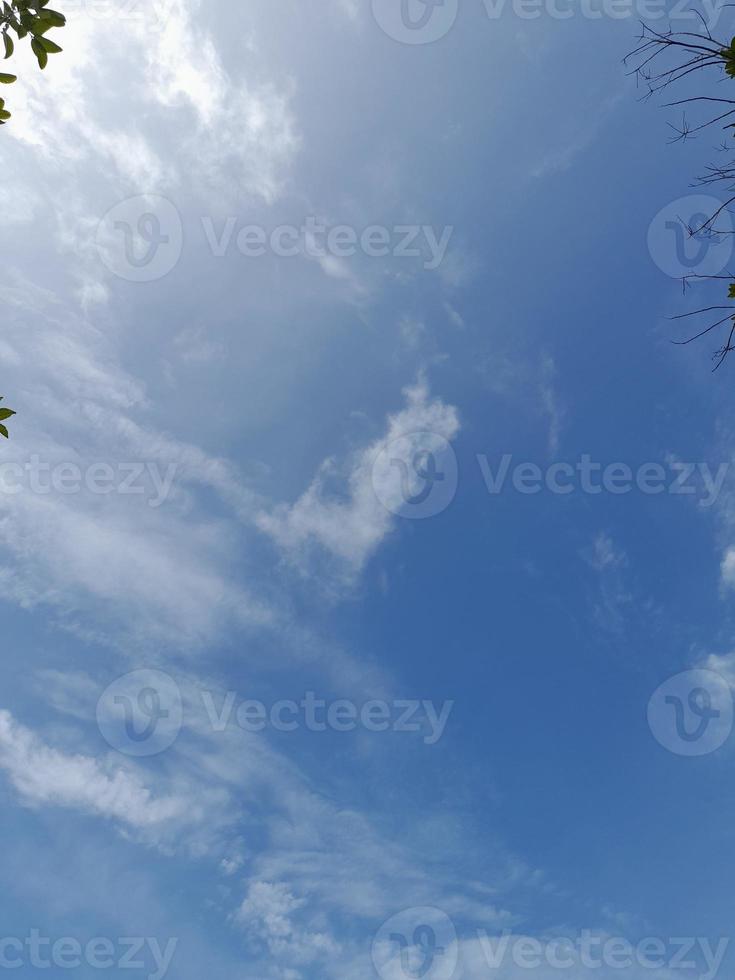 Beautiful white clouds on deep blue sky background. Large bright soft fluffy clouds are cover the entire blue sky. photo