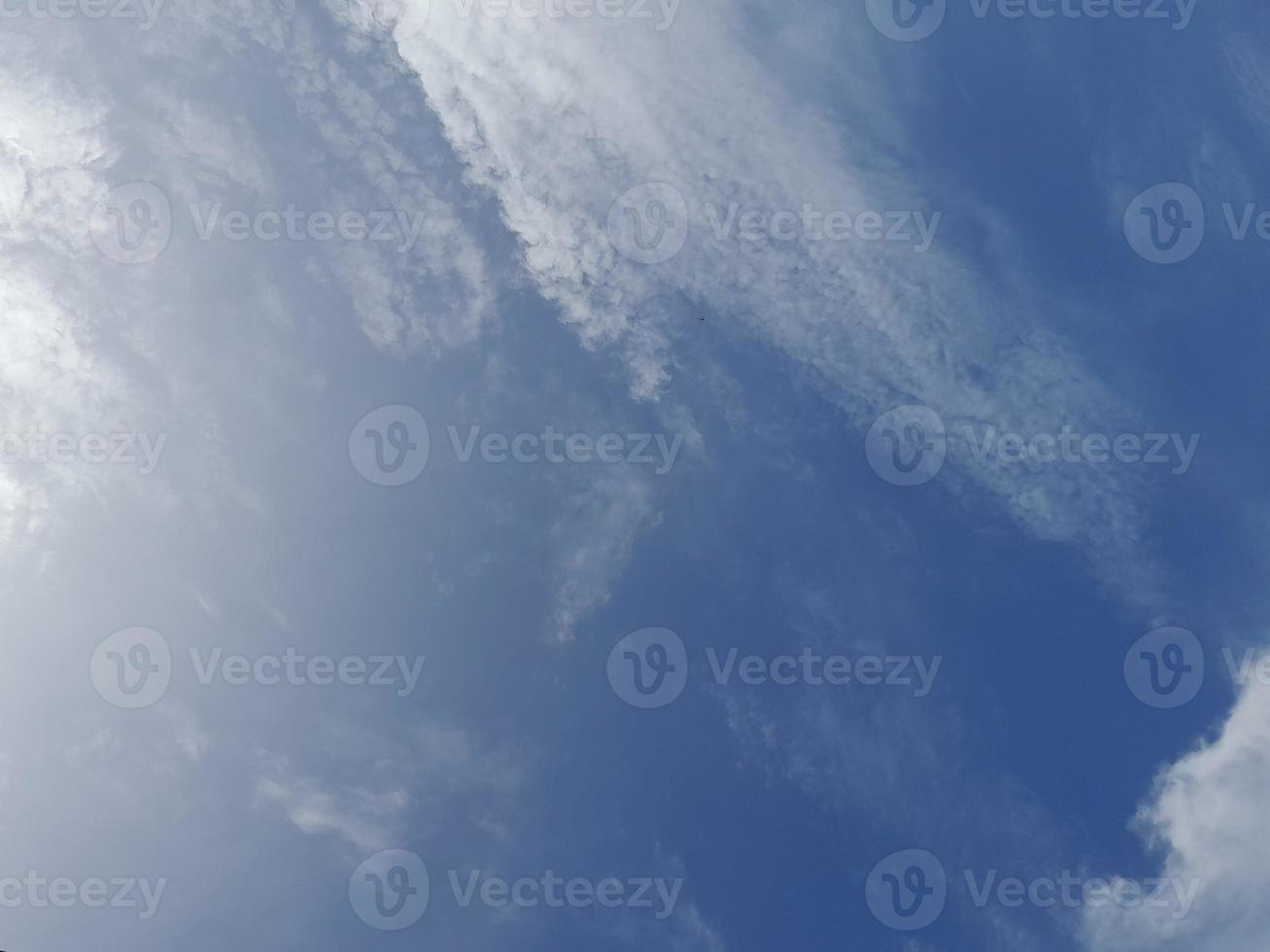 Beautiful white clouds on deep blue sky background. Large bright soft fluffy clouds are cover the entire blue sky. photo